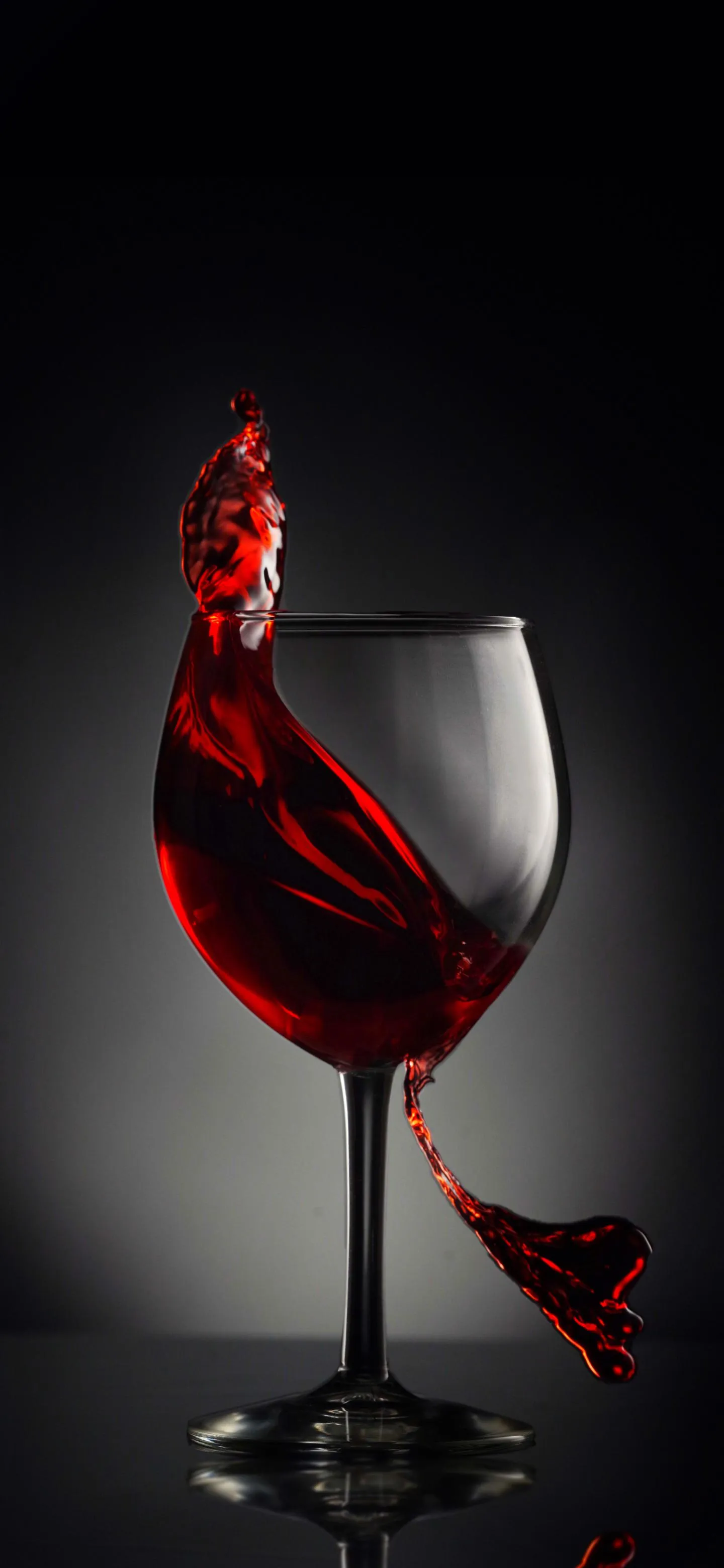 Red Wine Glass Splash in Elegant Dark Background Wallpaper