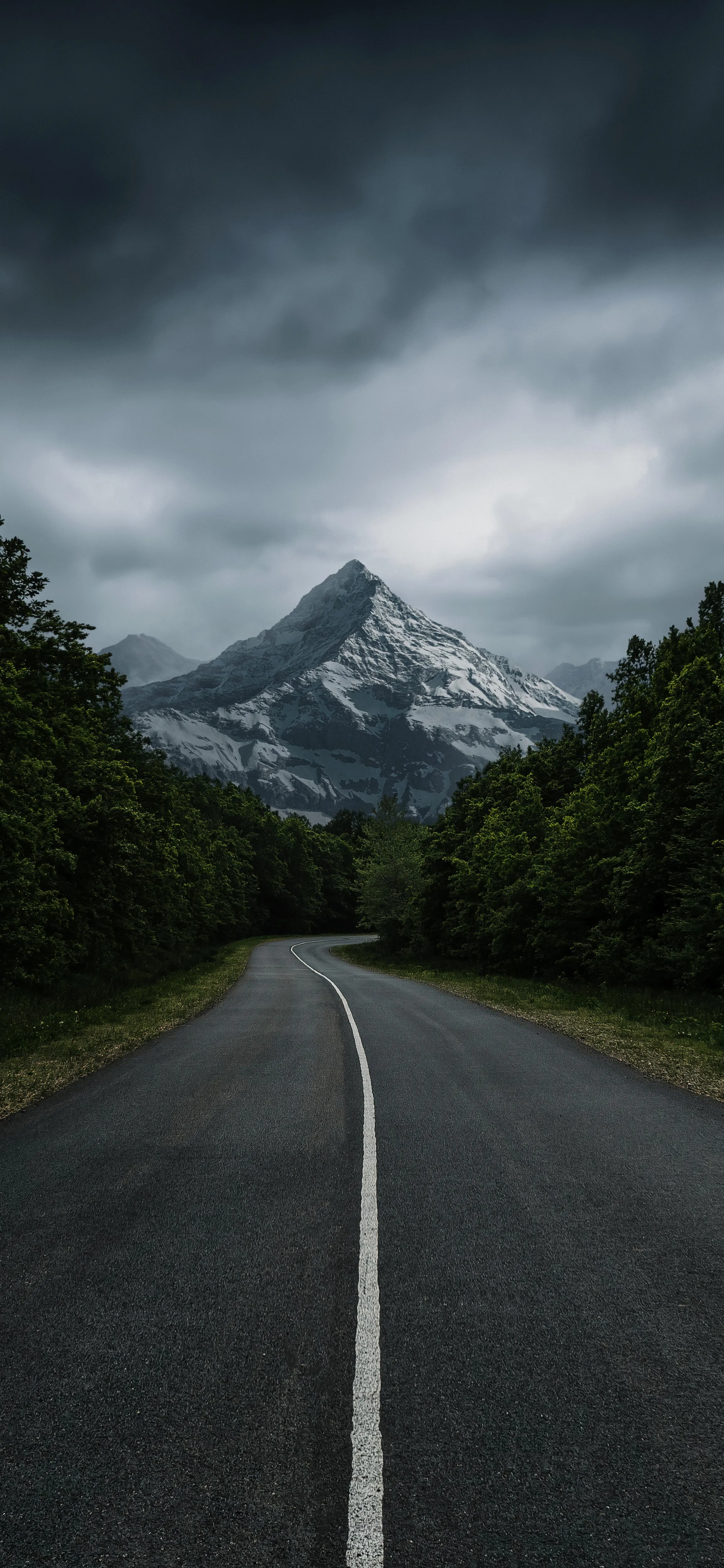 Road Leading To Mountains Under a Stormy Sky Image HD