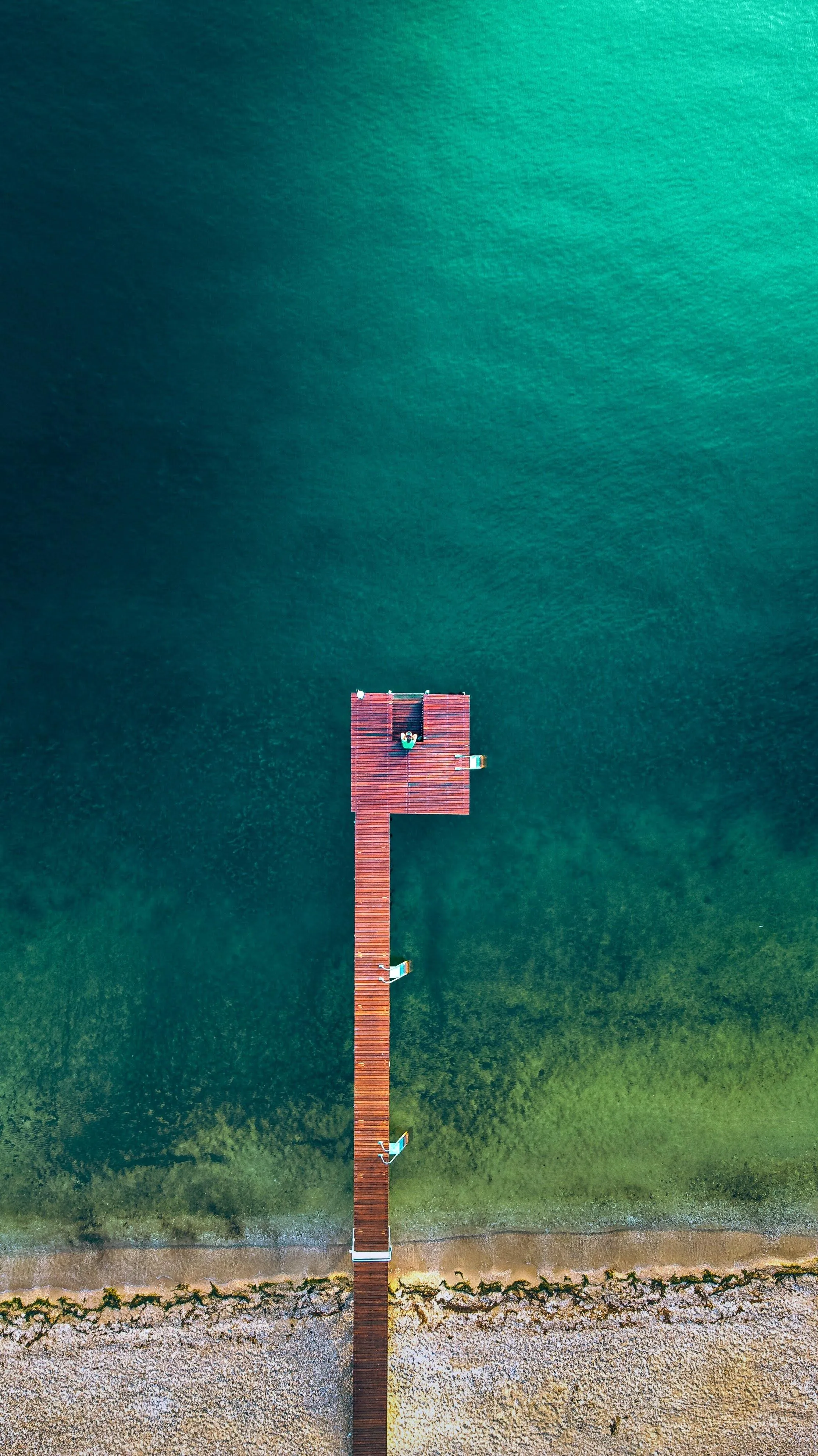 Rusty Wooden Pier in Beautiful Clear Lake Water Image