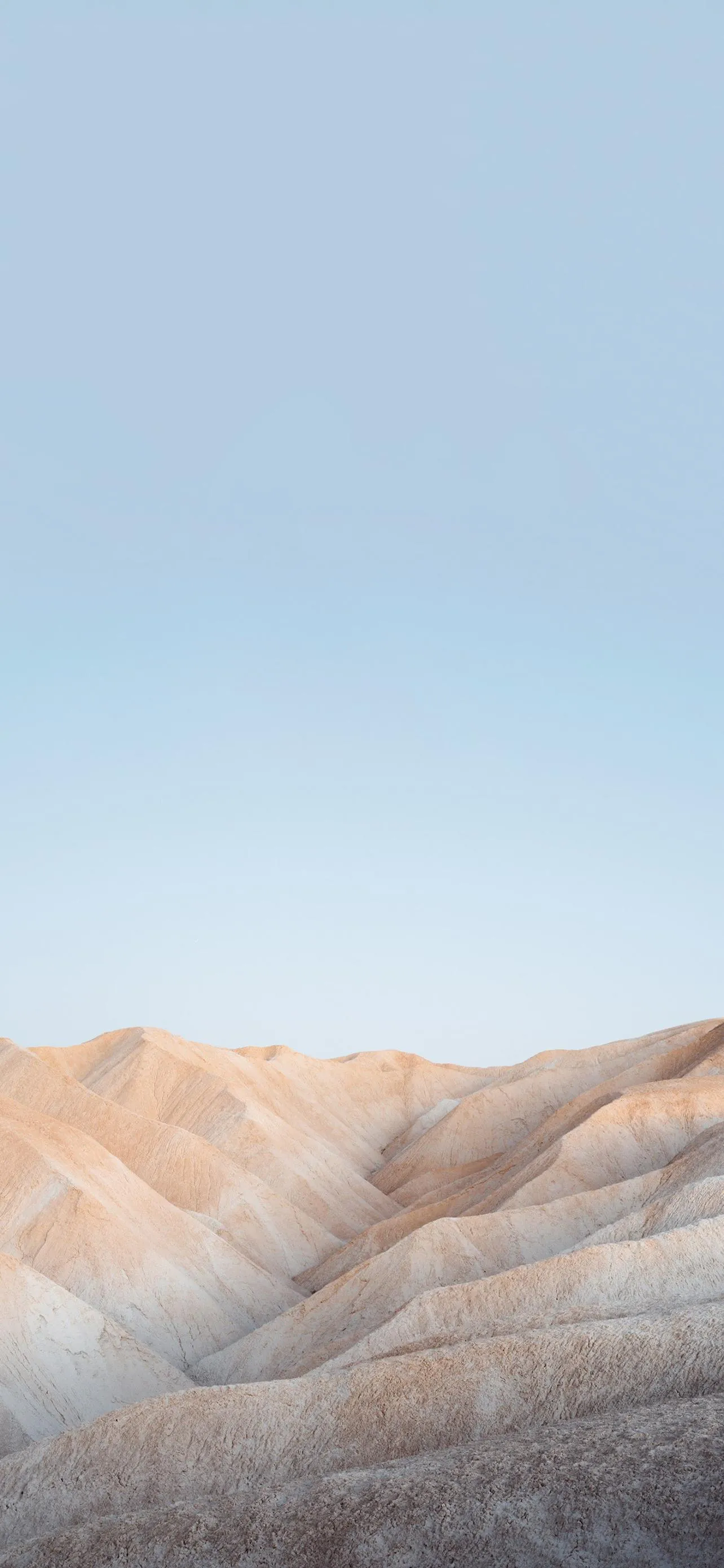 Sandy Rock Formations Under Clear Blue Sky Wallpaper