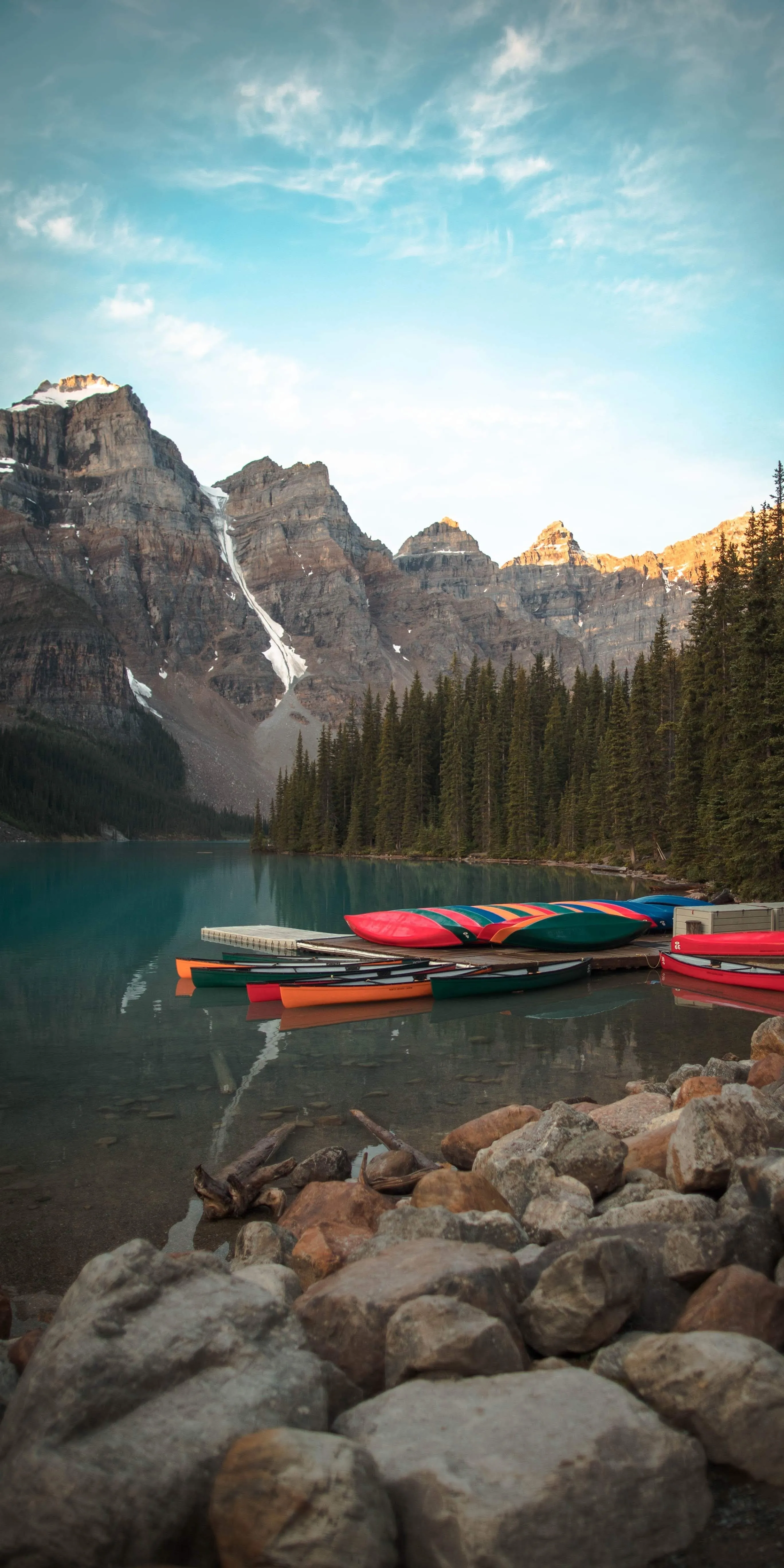 Scenic Mountain Lake with Canoes and Clear Sky View