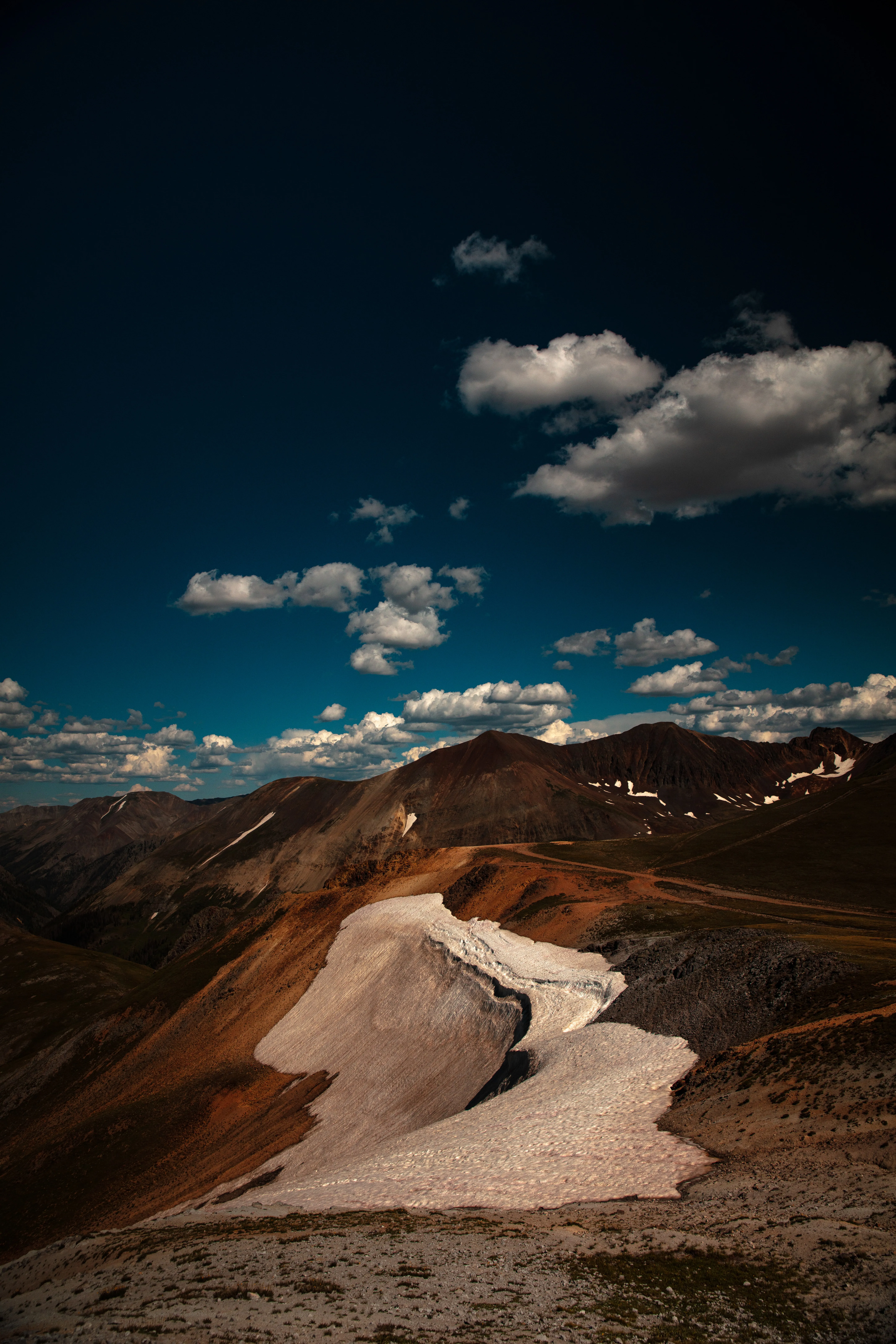 Scenic Mountain Range under Dramatic Sky View Wallpaper