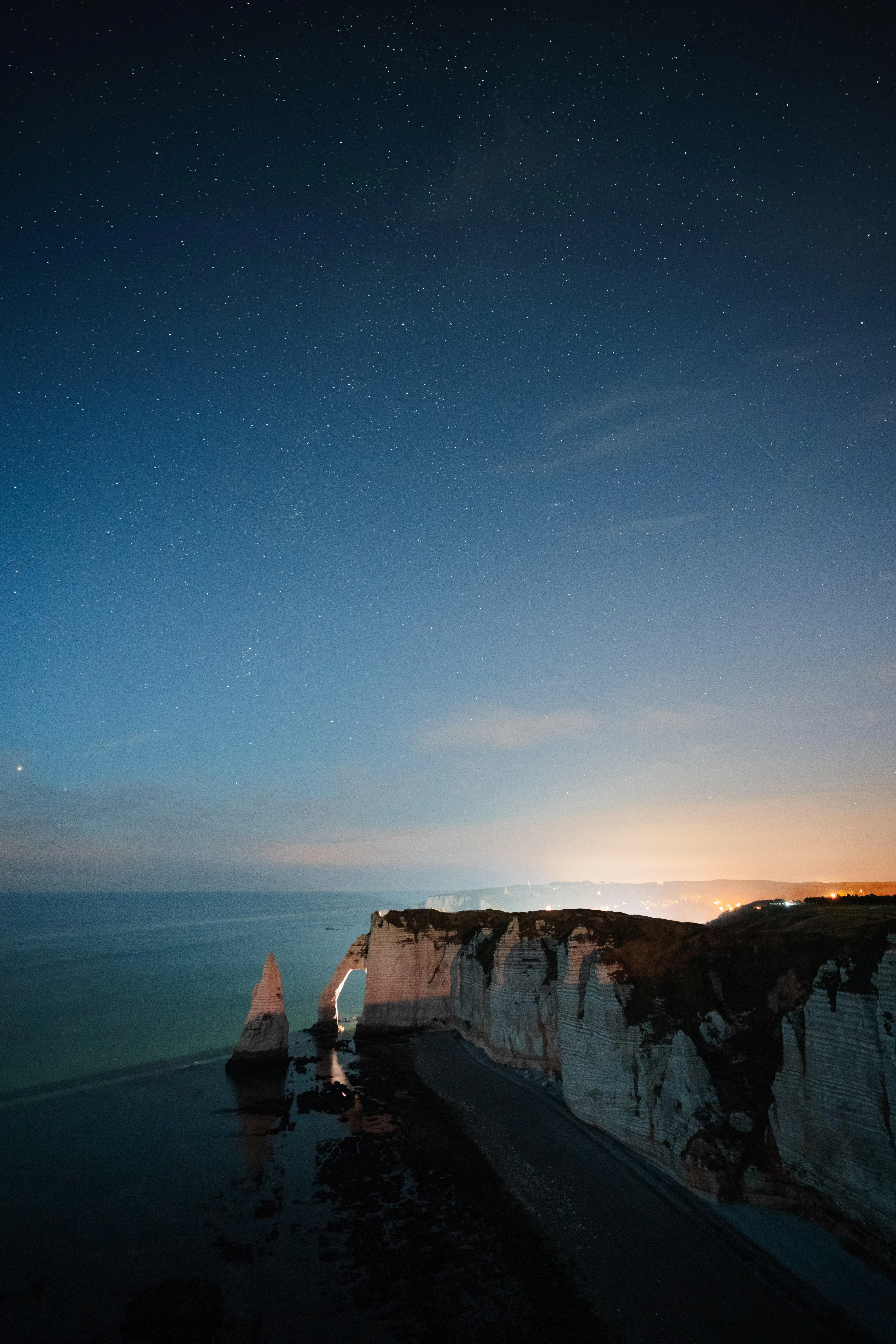Serene Coastal Cliffs Under Evening Sky and Calm Sea