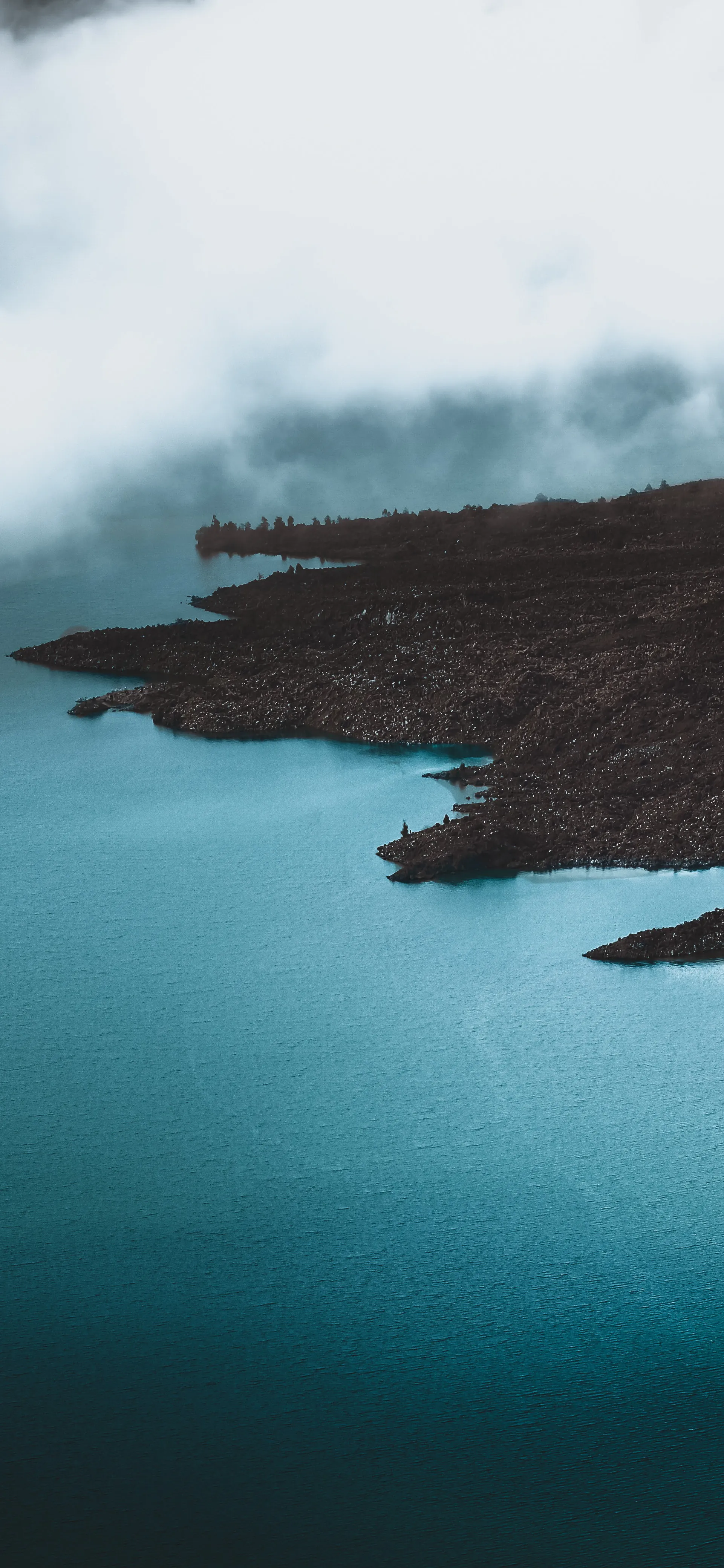 Serene Lake View with Misty Mountains in Background