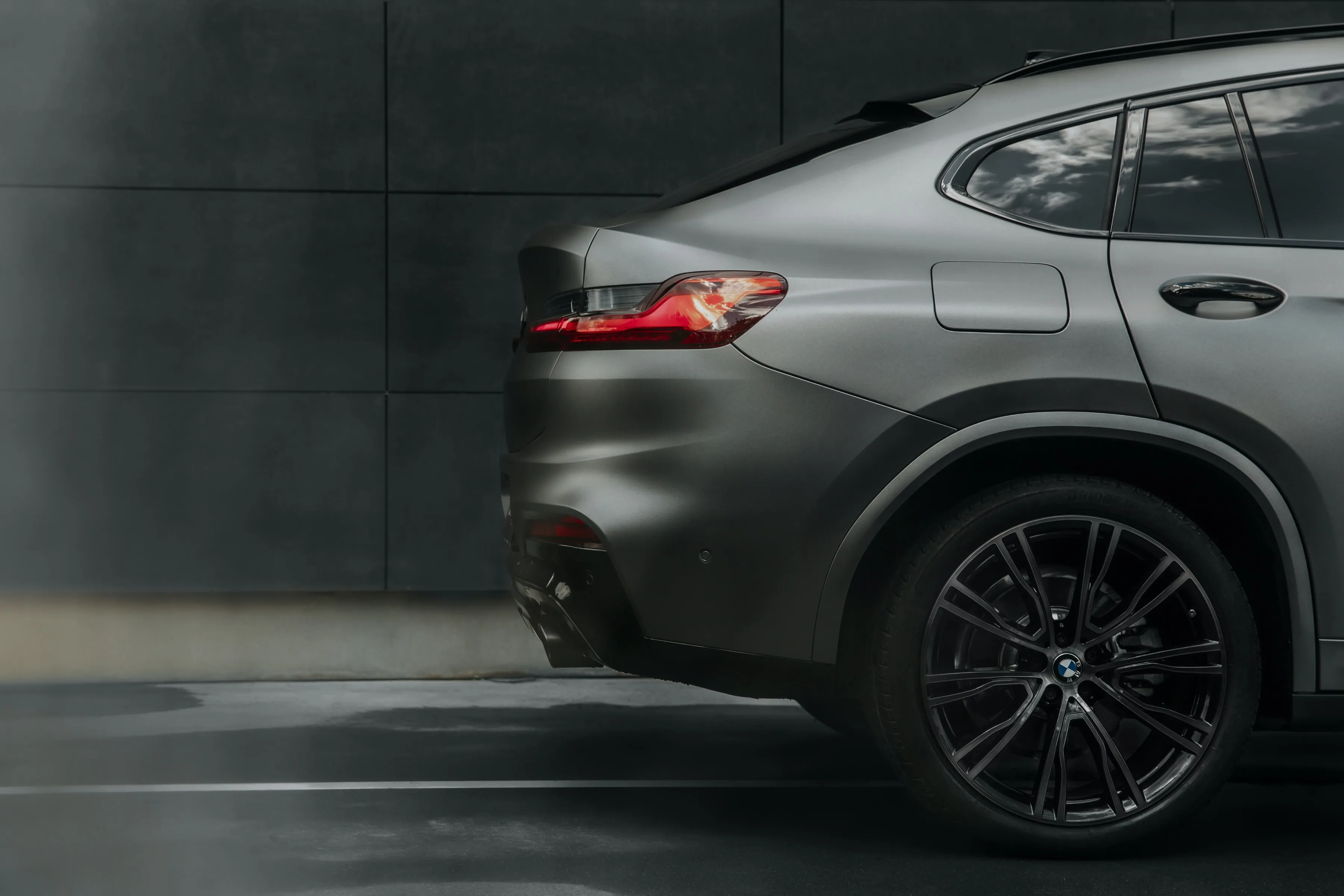 Side Profile of Modern Gray Car Driving on a Wet Road