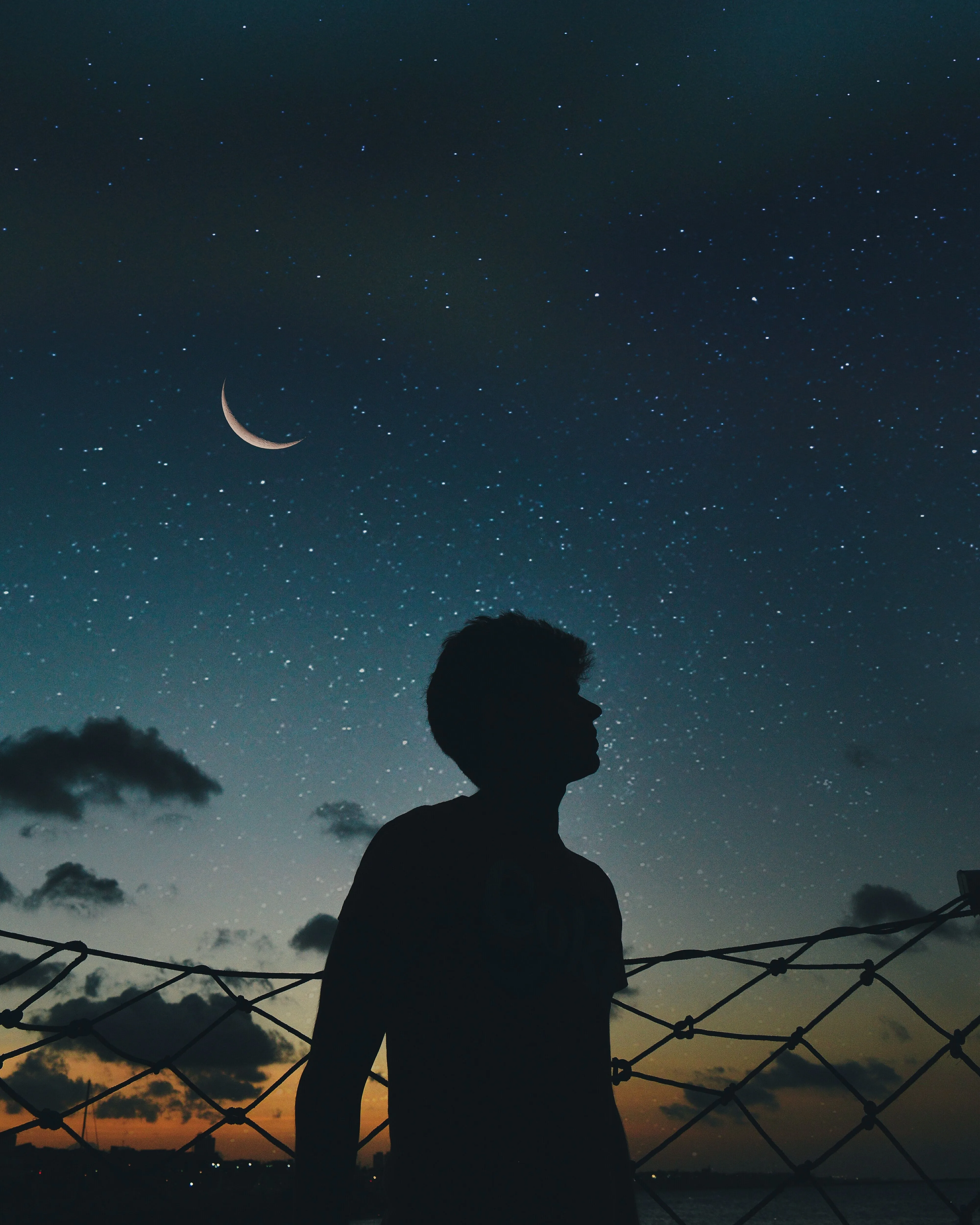 Silhouette of Boy Watching Stars in Night Sky Wallpaper