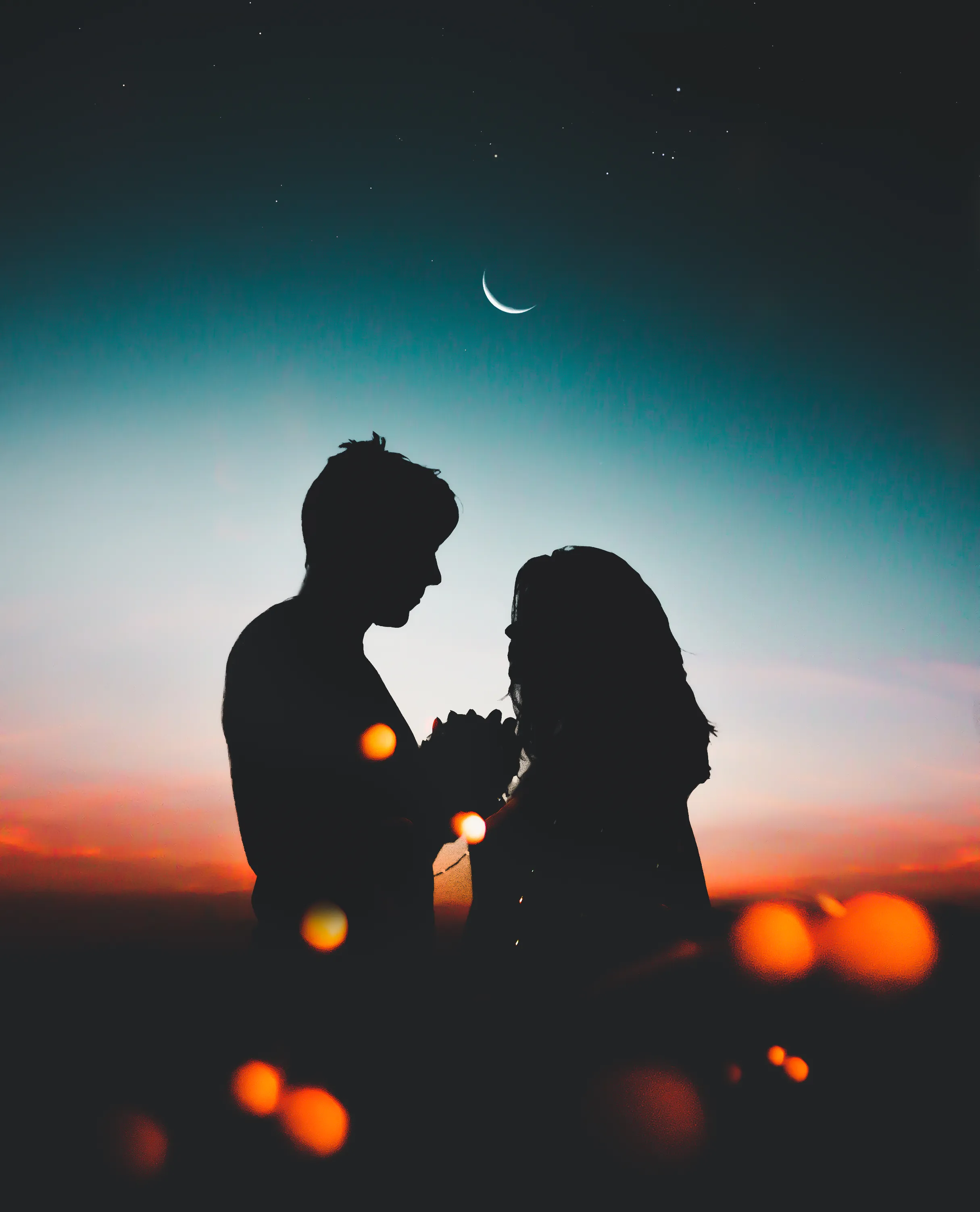 Silhouette of Couple at Sunset Under Starry Sky Wallpaper
