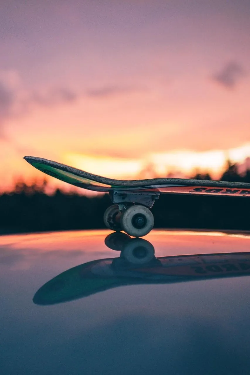 Skateboard Resting Under Sunset Sky of Calm Freedom