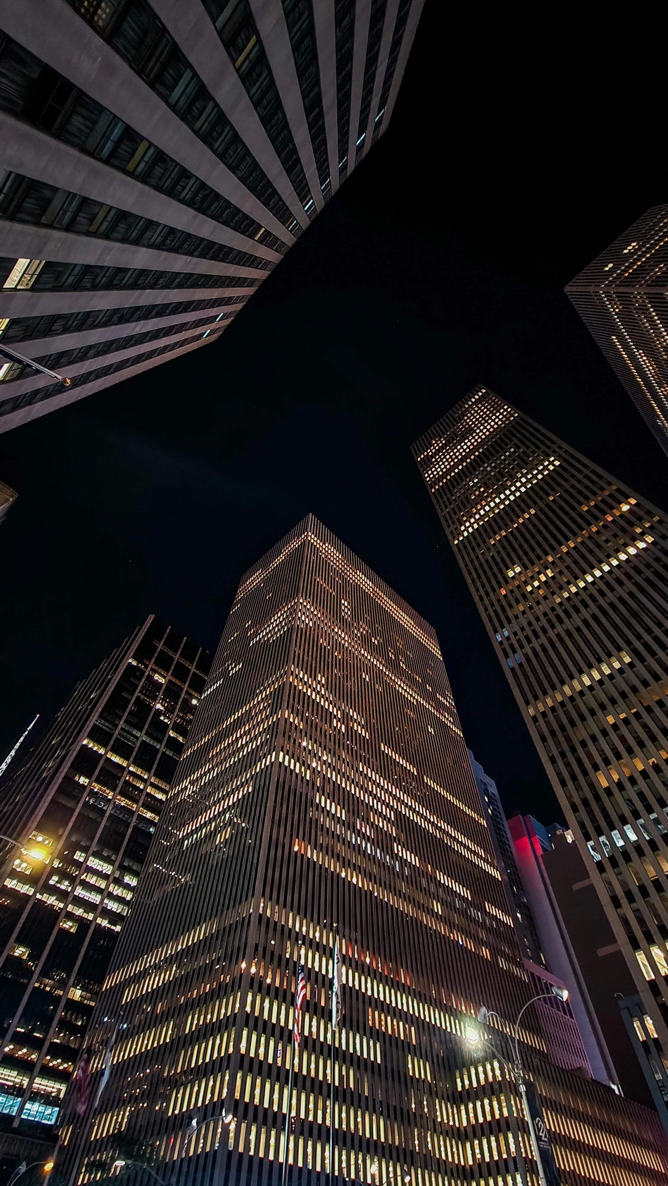 Skyscraper View with City Lights at Night Wallpaper