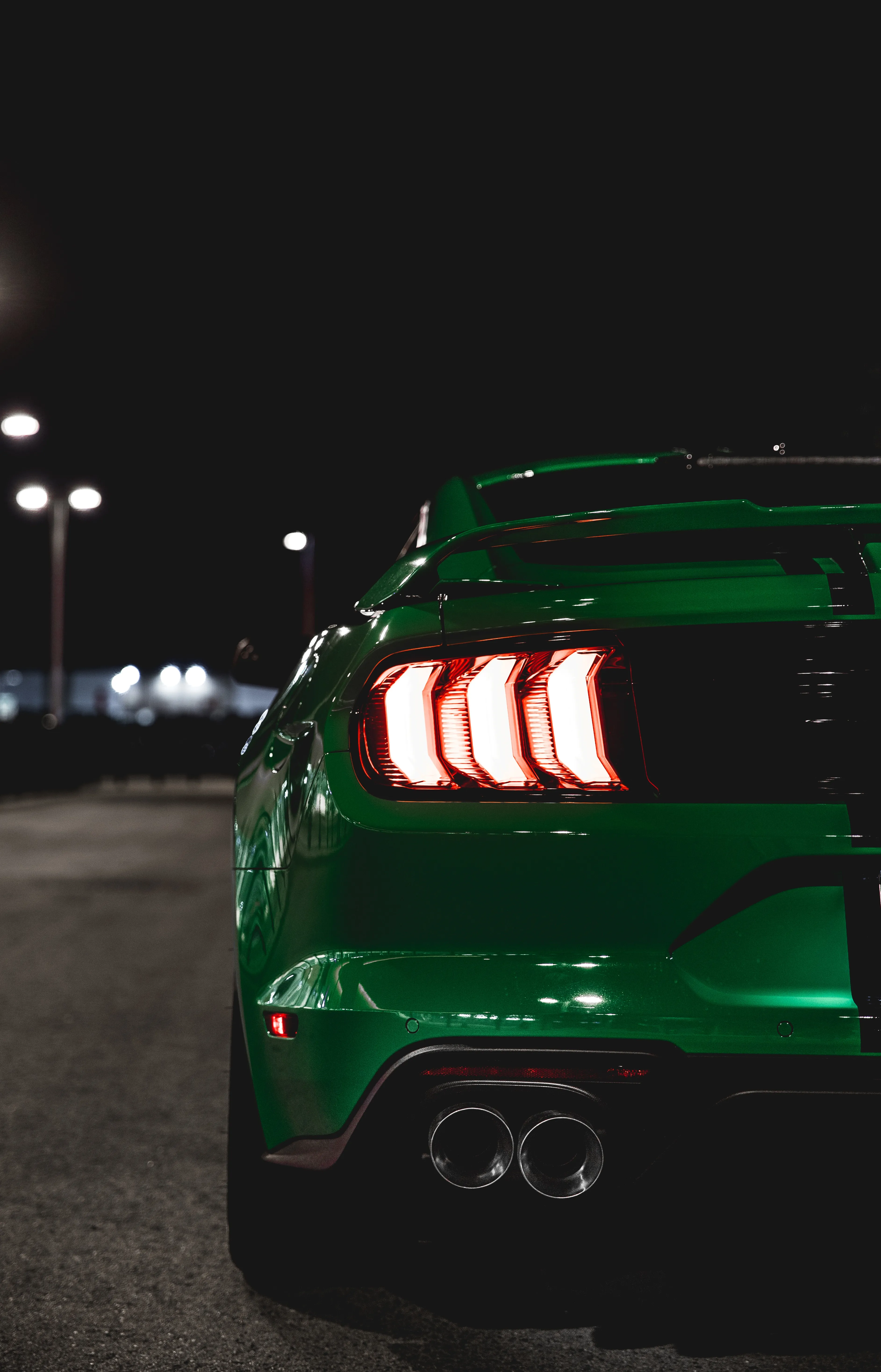 Sleek Green Sports Car in the City Night Wallpaper