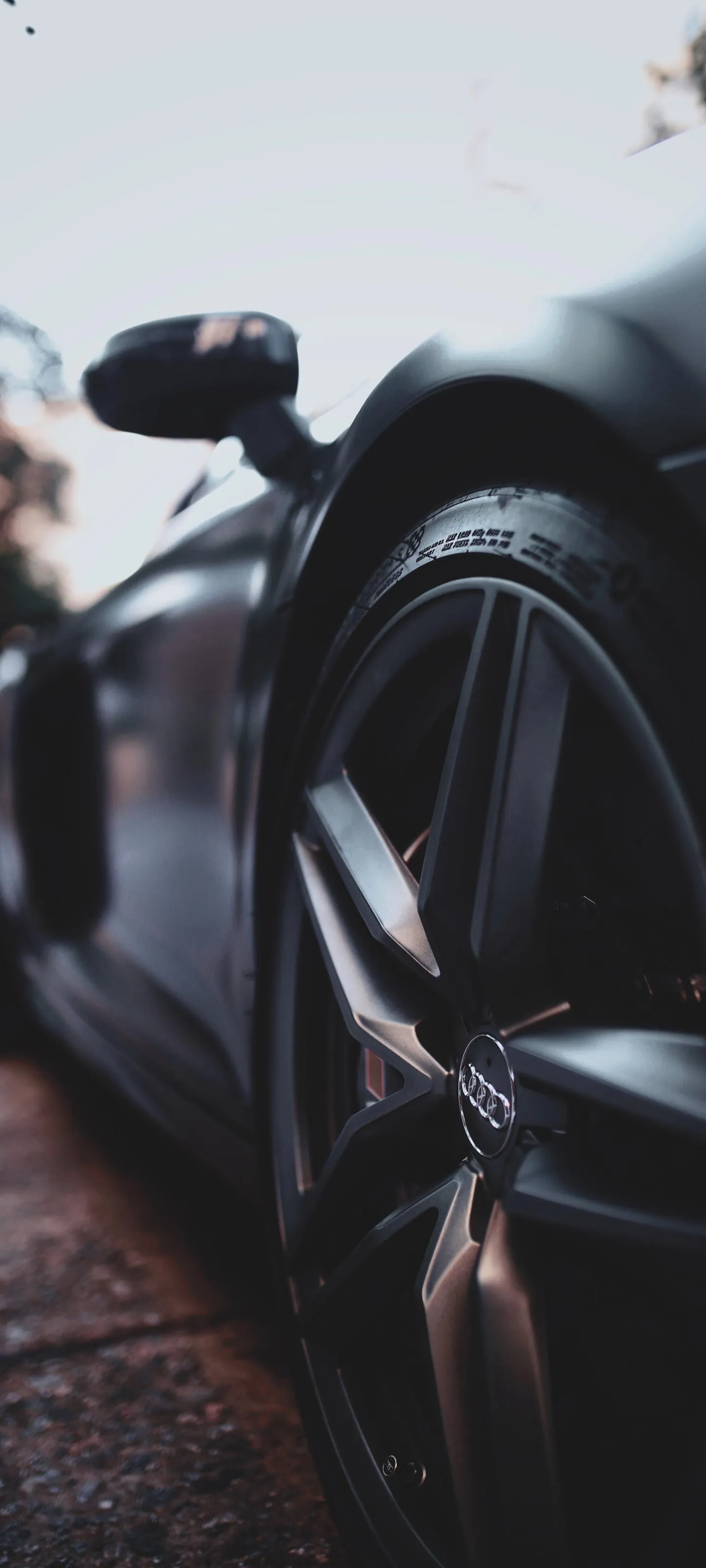 Sleek Sports Car Close Up with Urban Background Wallpaper