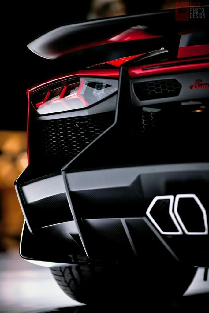 Sleek Sports Car Rear Lights Glowing in Dark Scene Wallpaper