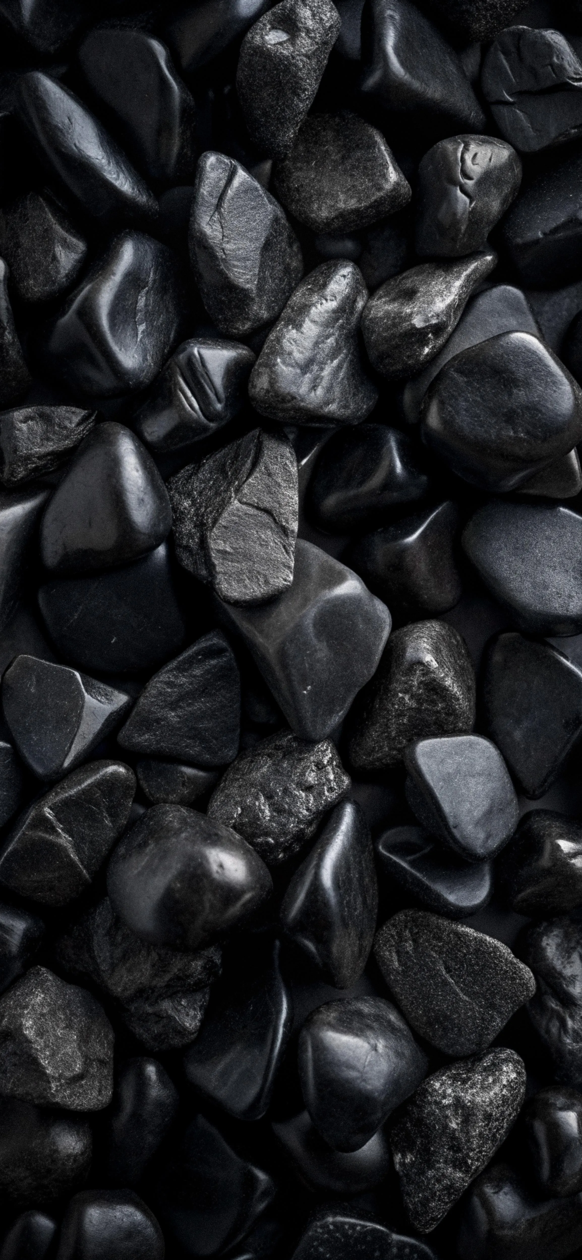 Smooth Black Stones Arranged on a Dark Clean Surface Image