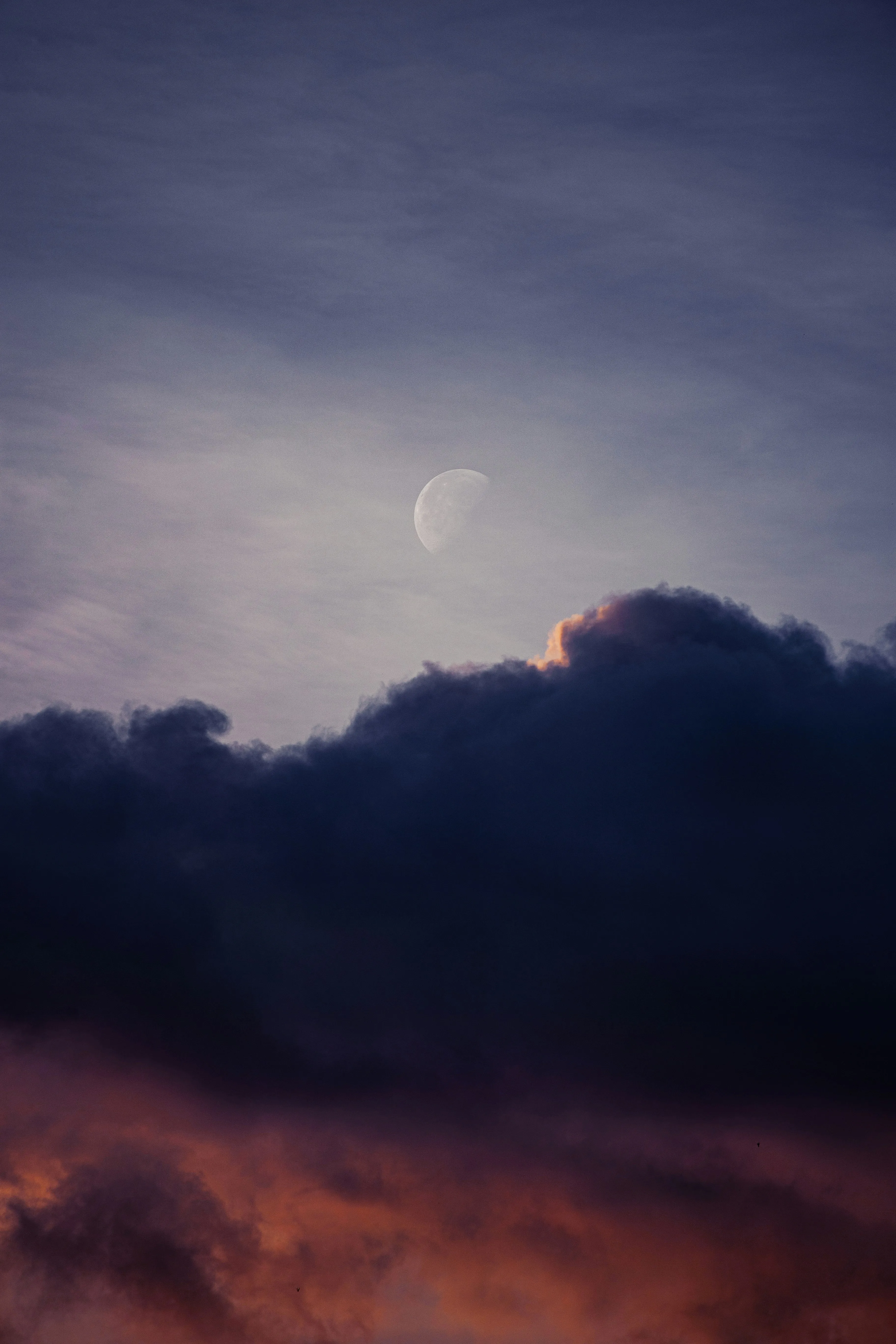 Soft Purple Clouds Floating Across Evening Sky Wallpaper
