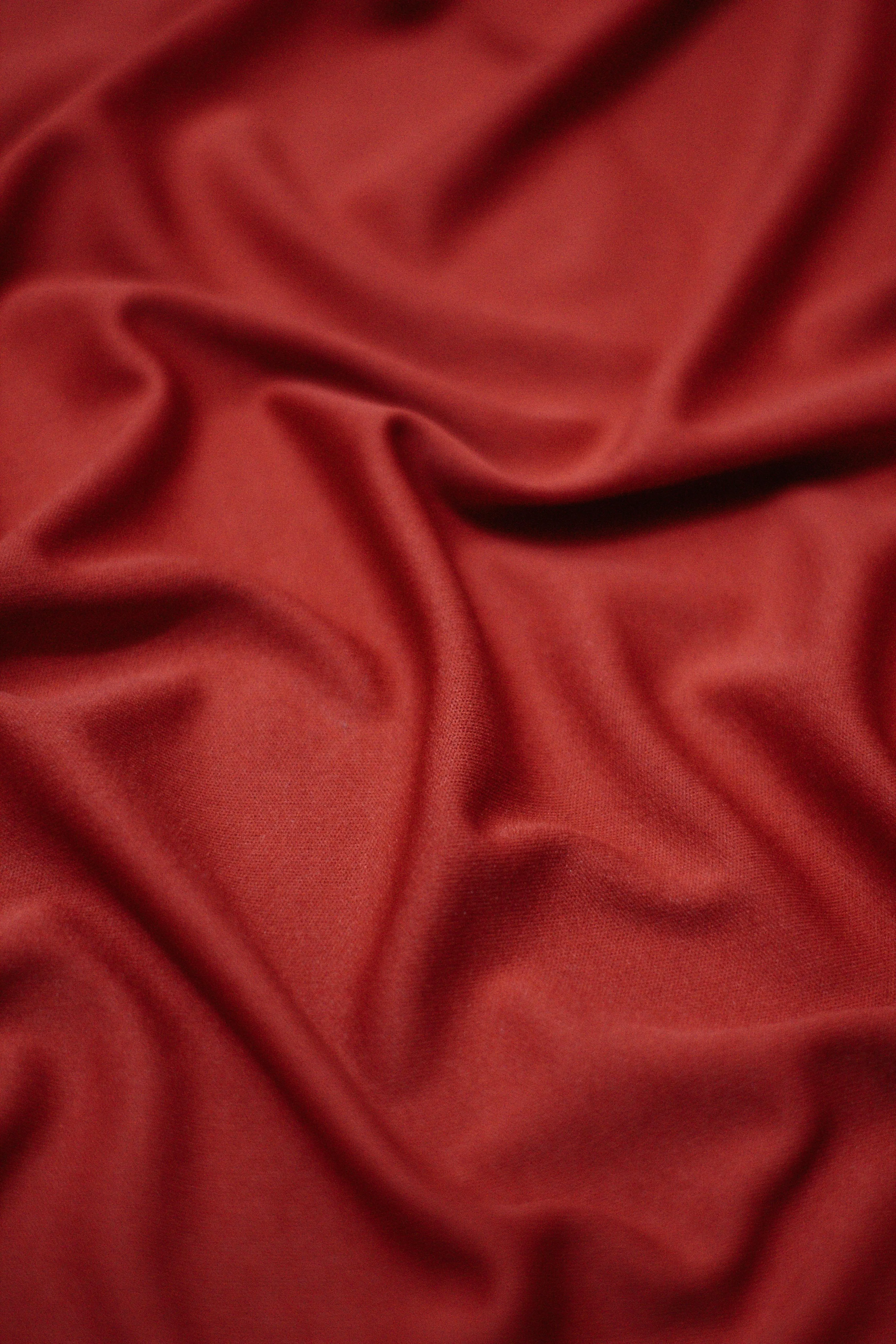 Soft Red Fabric with Smooth Texture and Wrinkles Wallpaper