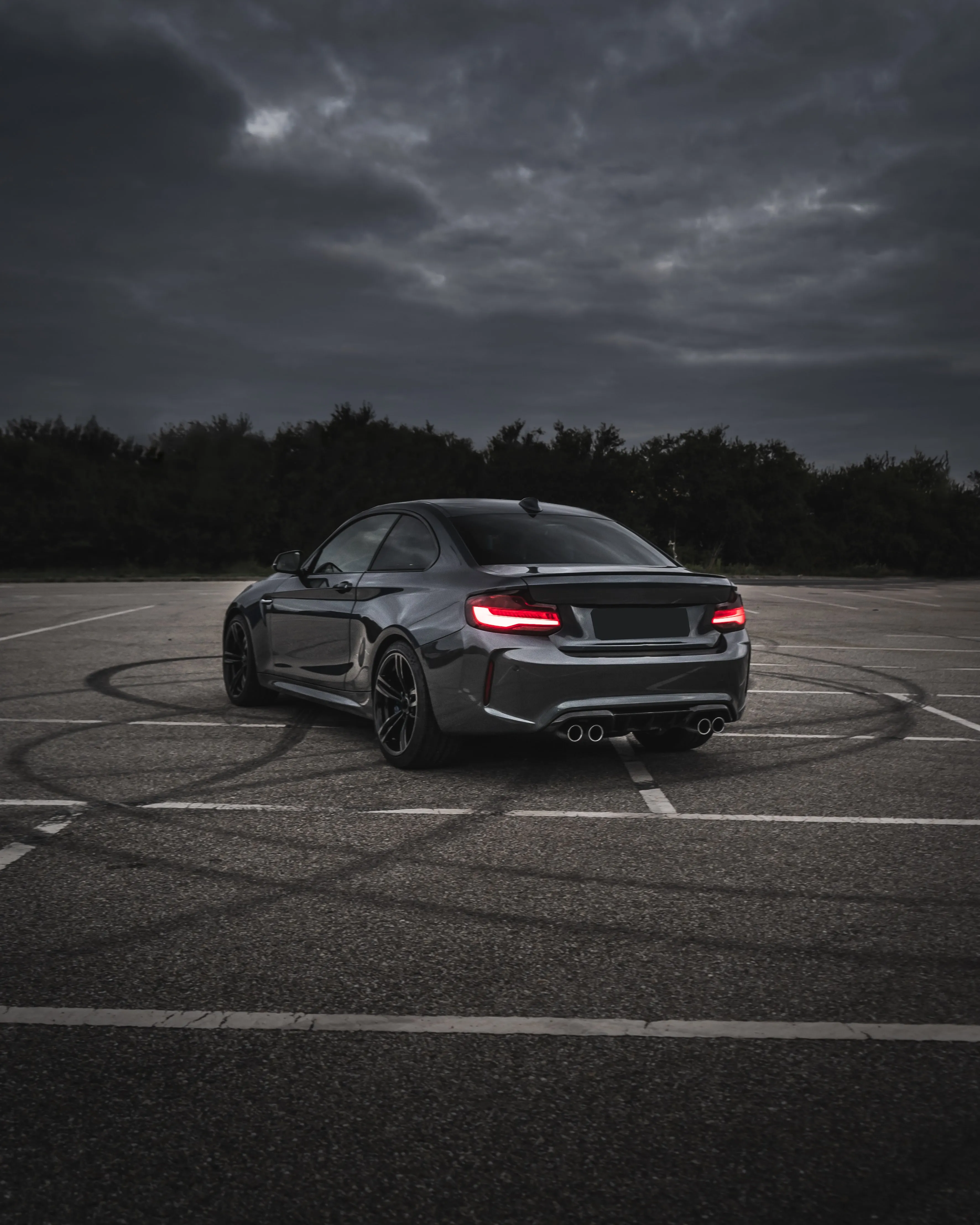 Sports Car Parked on Street at Twilight Hour Wallpaper