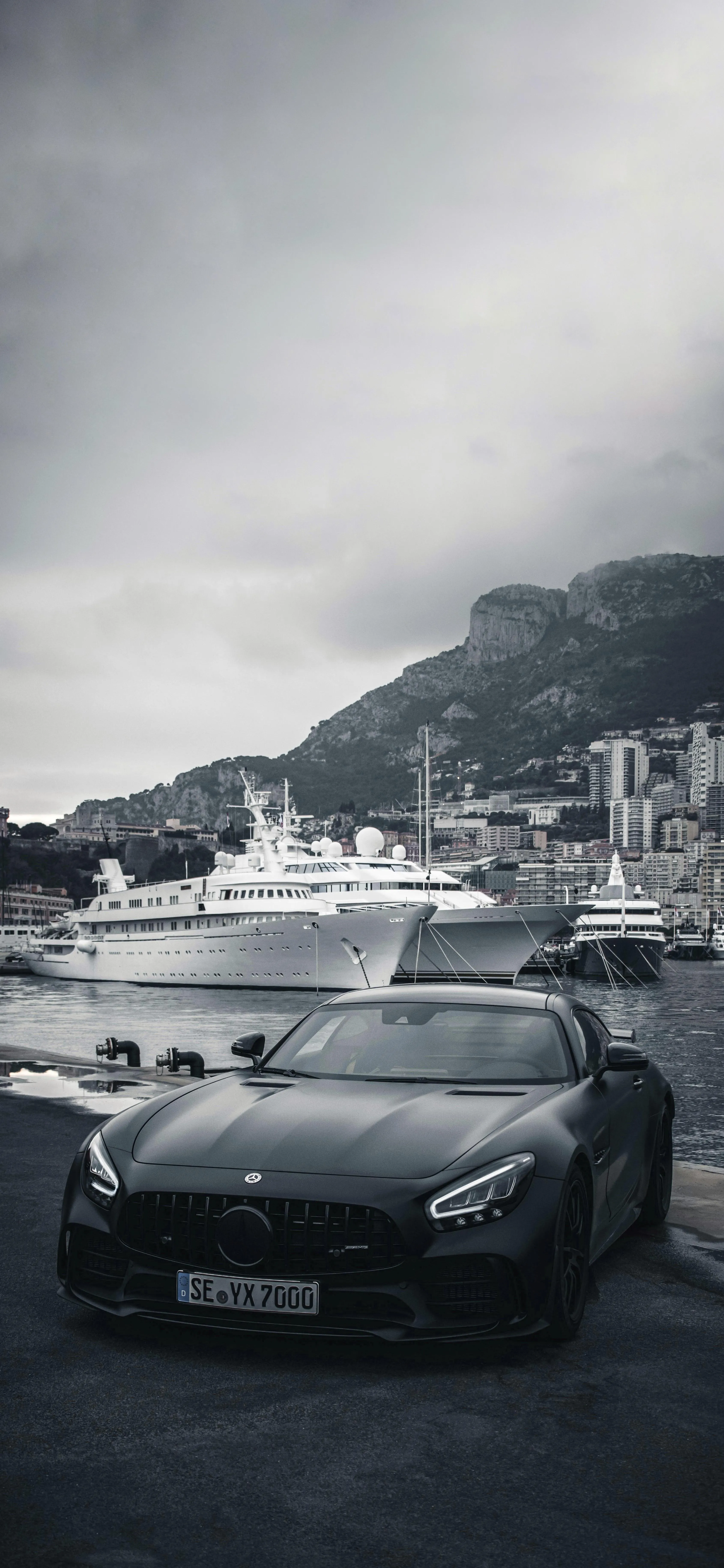 Sports Cars in Black and White on Mountain Road Near Ships
