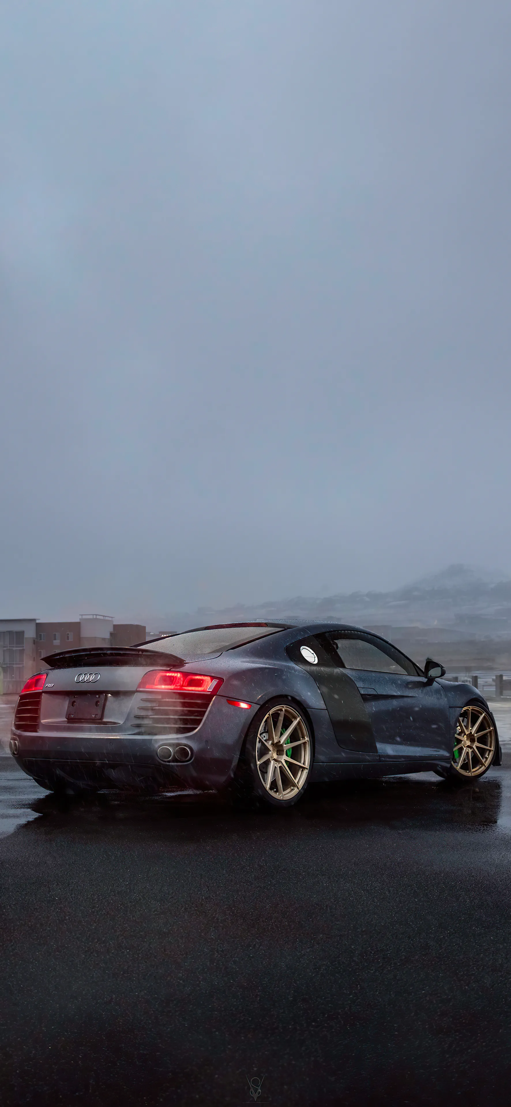 Sporty Car Driving Through Foggy City Streets at Dawn