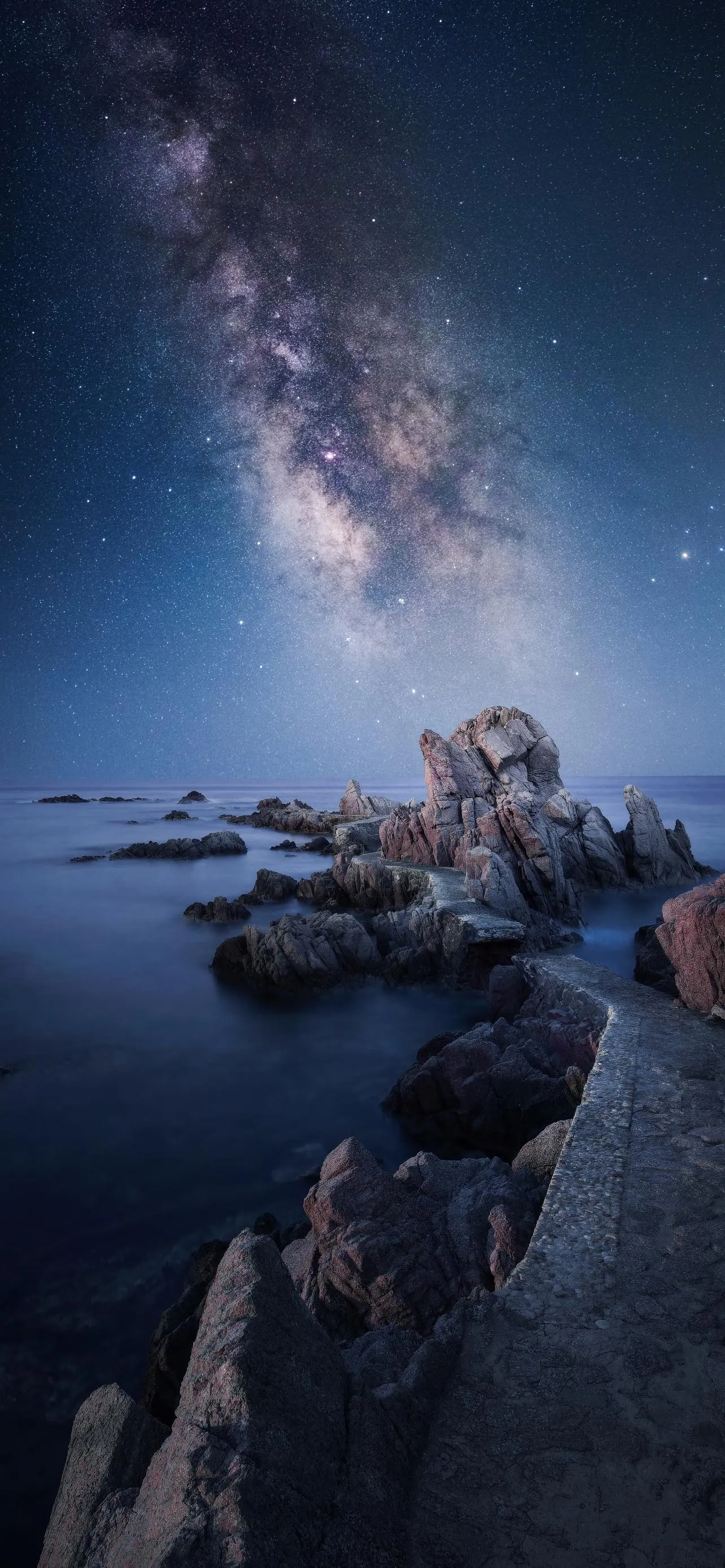 Starry Night Sky Over Rocky Shore with Milky Way Wallpaper