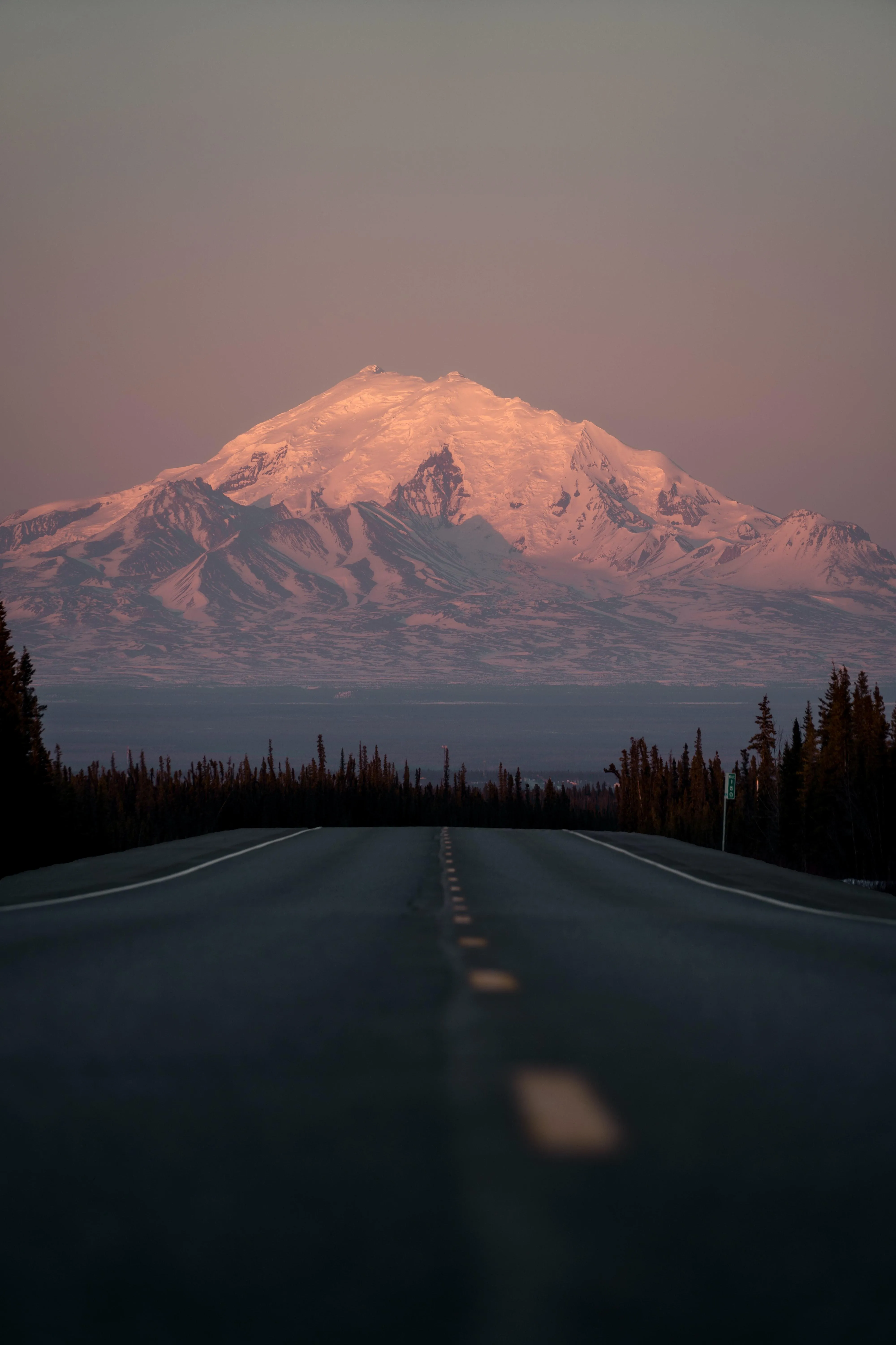 Sunset Light Casting Glow Over Distant Mountain Range