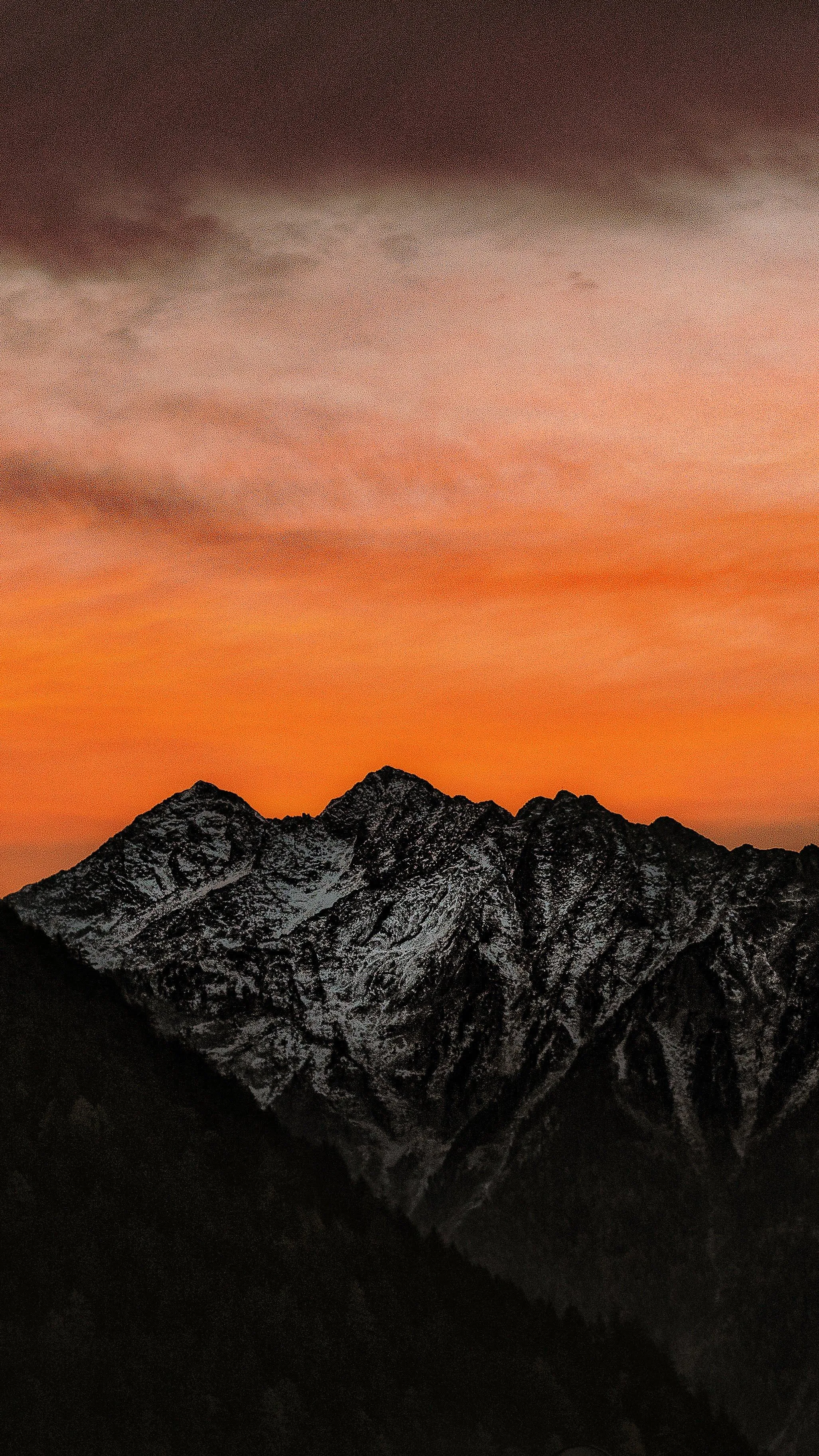 Sunset Over Mountain Range with Vibrant Orange Sky Image