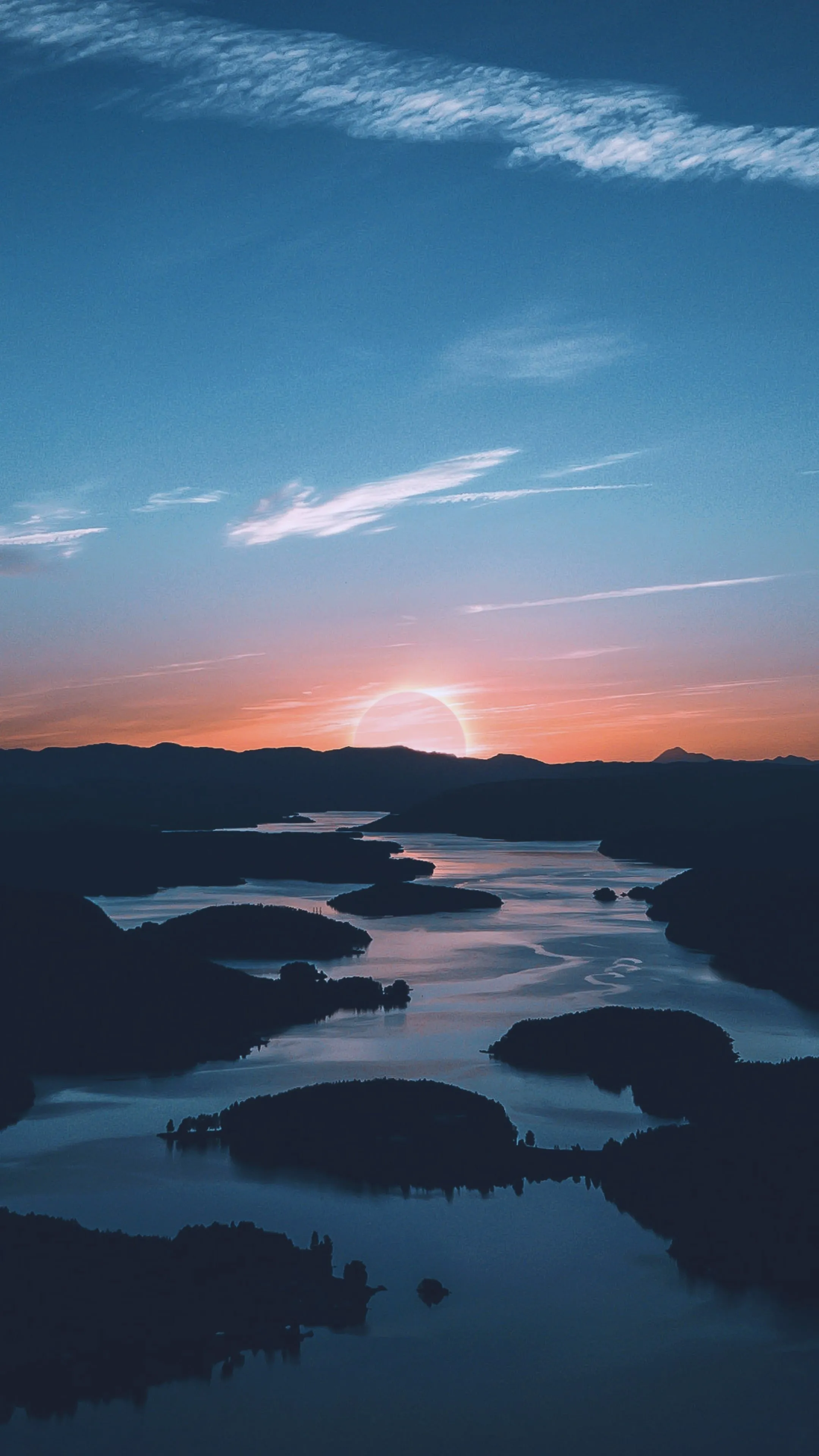 Sunset Over River and Mountains in Peaceful Landscape