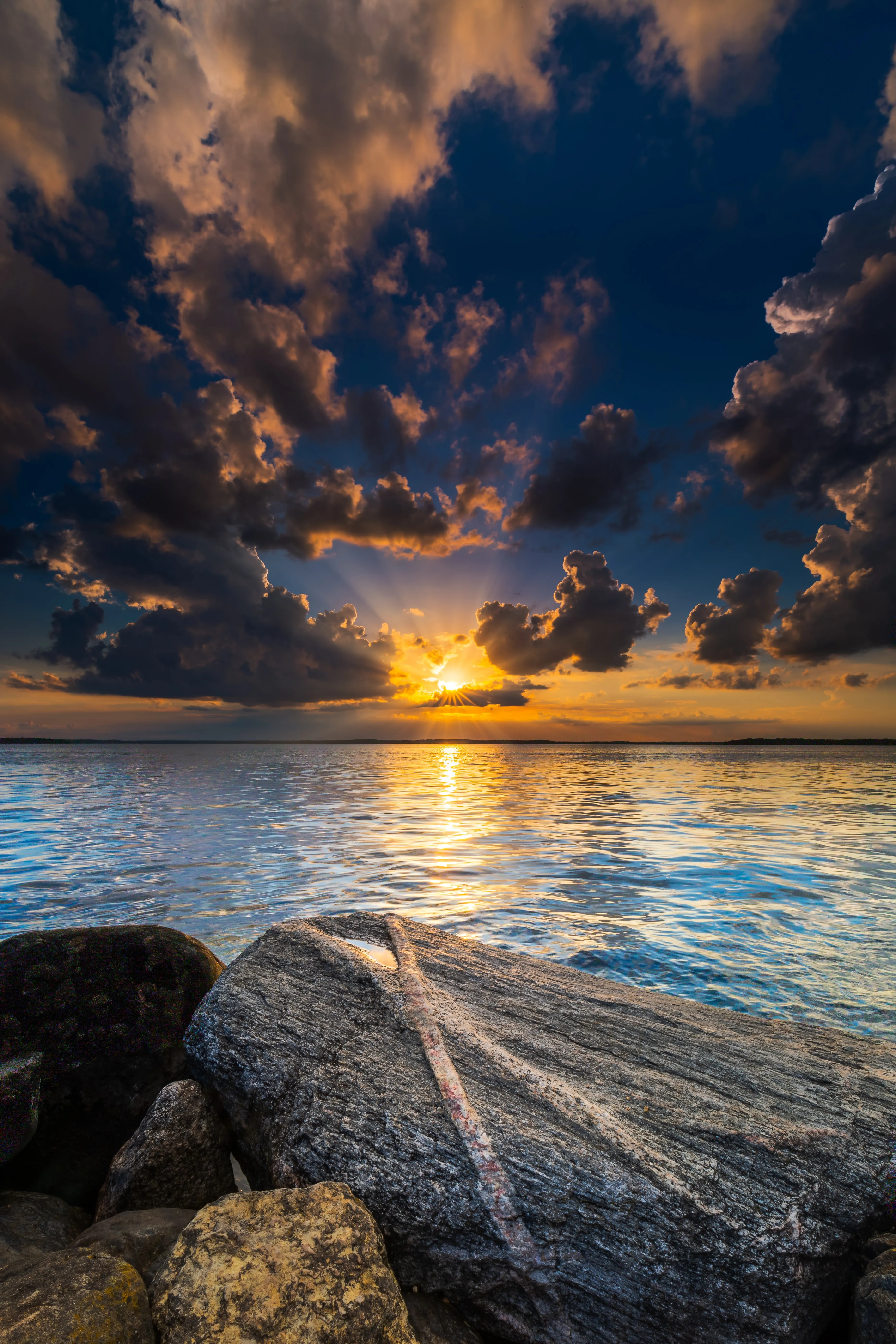 Sunset Over Rocky Beach with Sparkling Ocean Waves