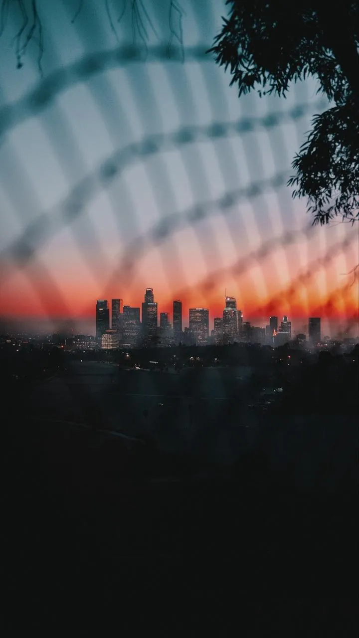Sunset through Metal Fence Urban View Wallpaper for Phones