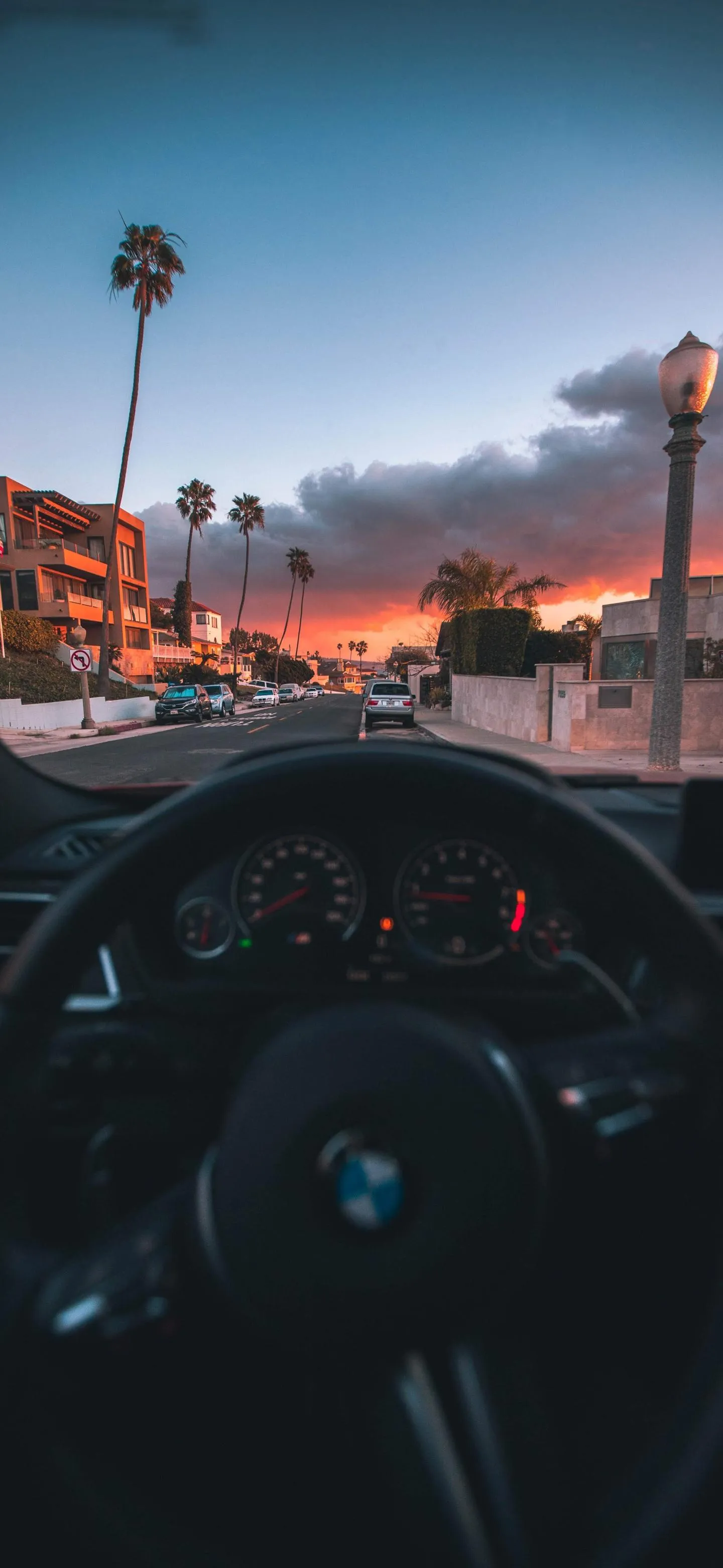 Sunset View From Car With Dashboard and Palm Trees