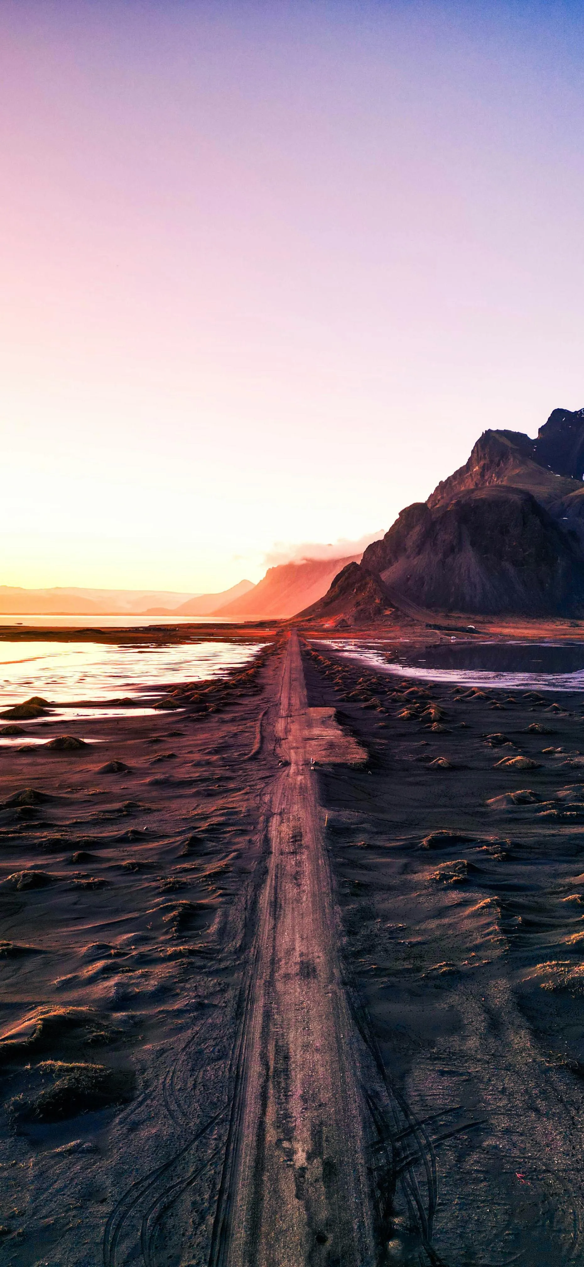 Sunset View of Pier Road Leading into Ocean Sky Wallpaper