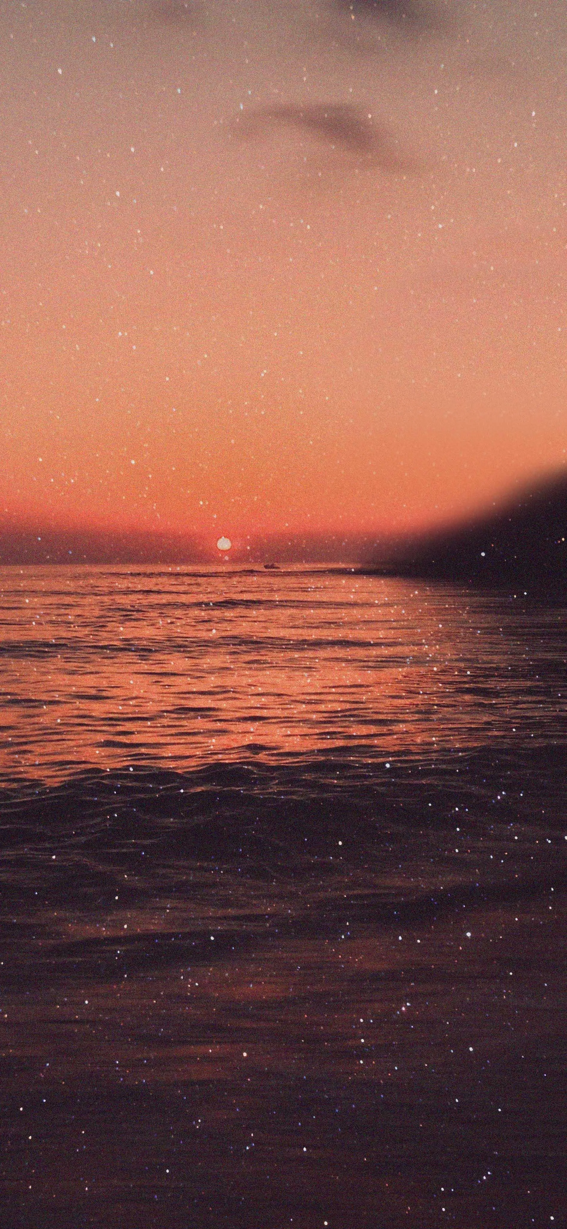 Sunset View Over Calm Ocean Waters with Warm Tones