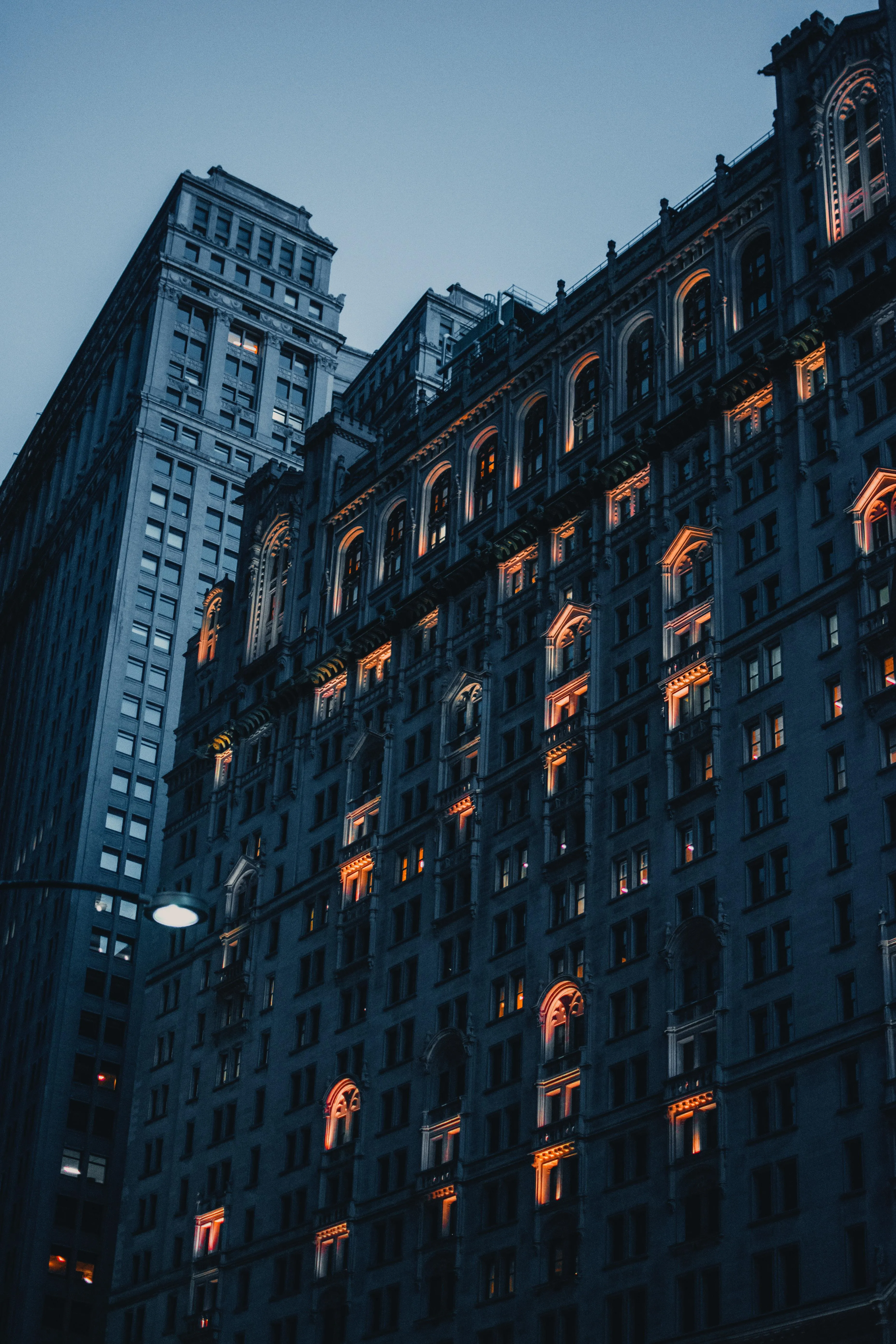 Tall Building with Illuminated Windows at Dusk Wallpaper