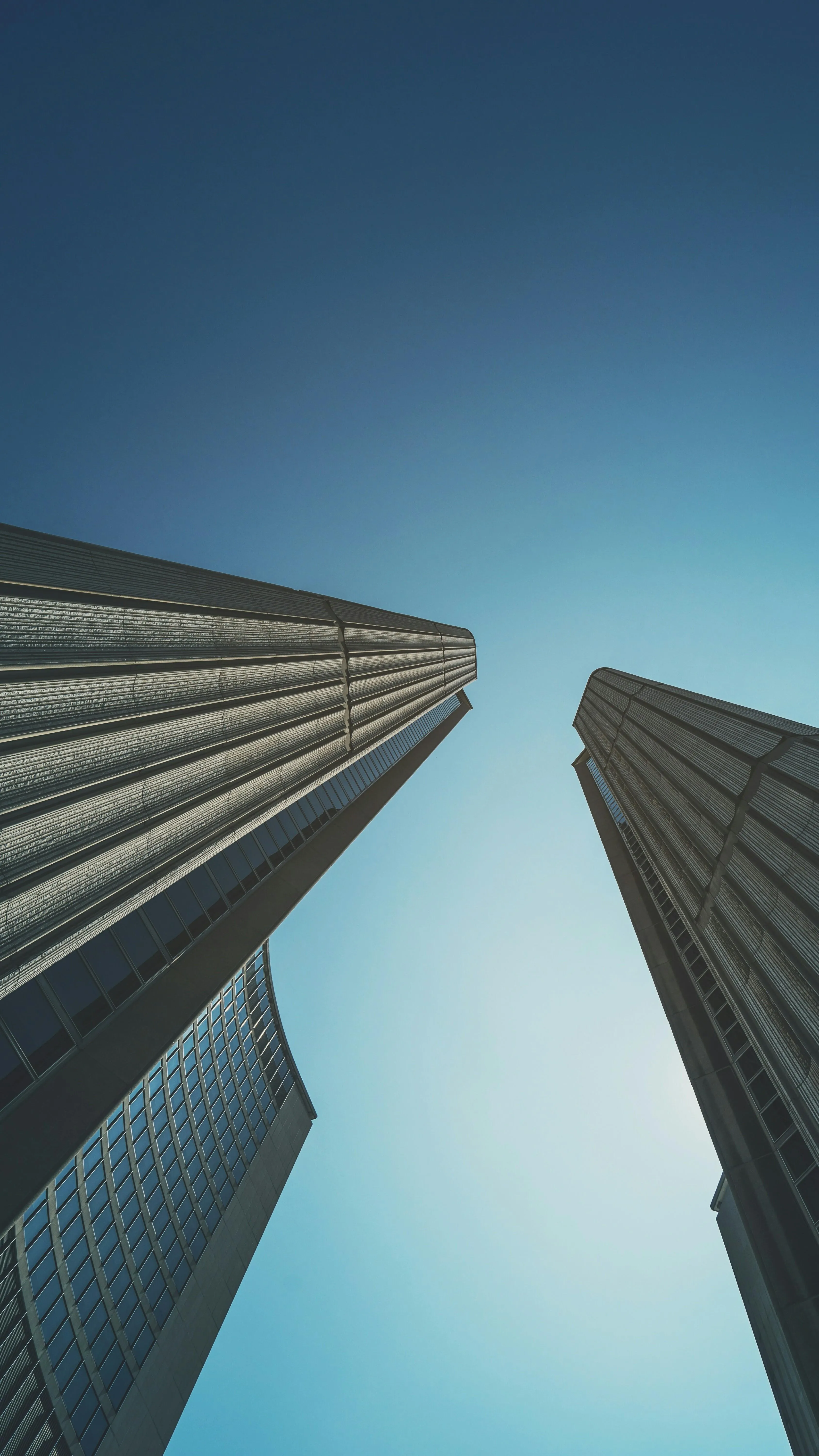 Tall City Buildings Reaching Upward Into a Blue Morning