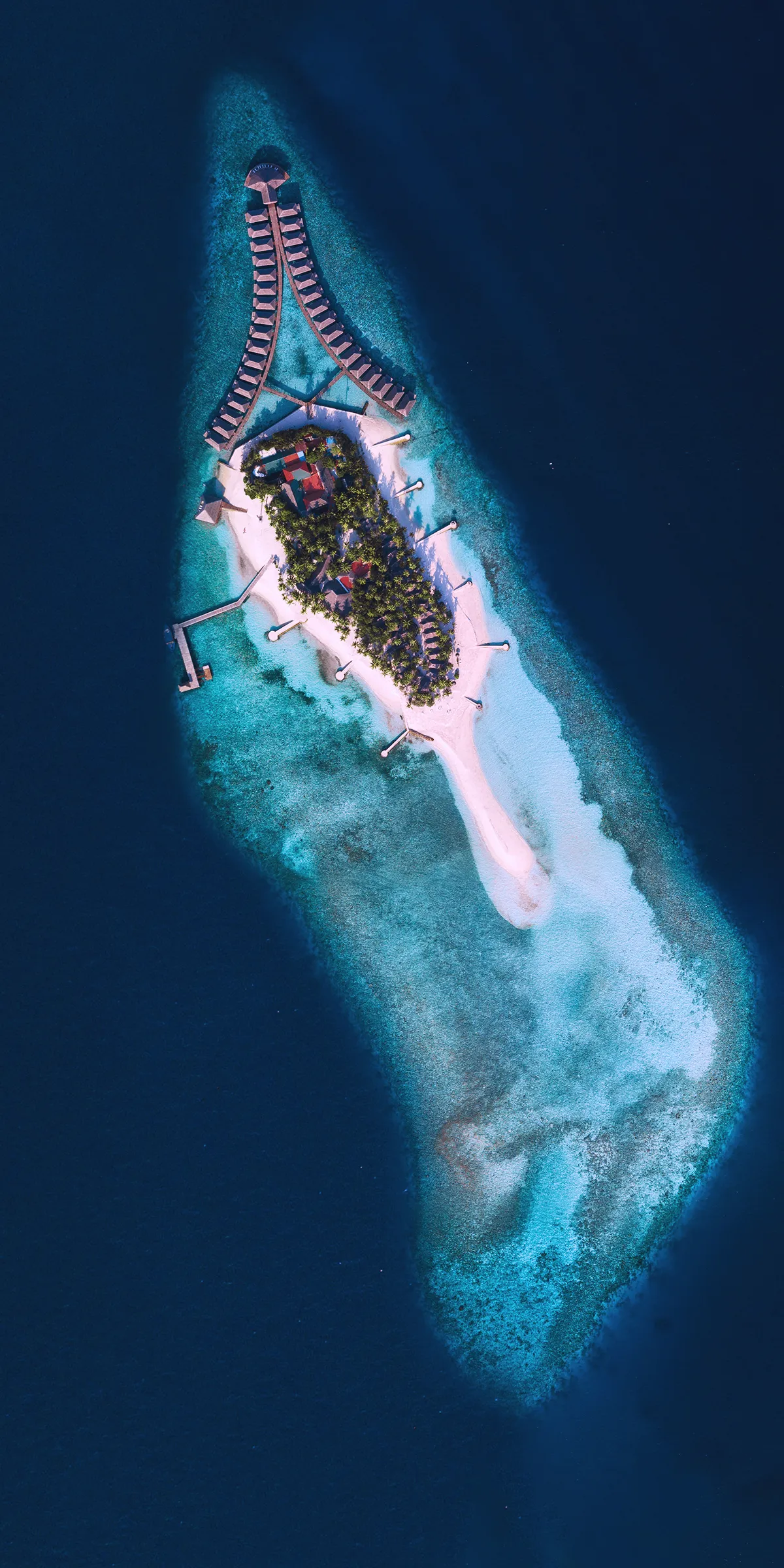 Tiny Island Surrounded by Deep Blue Ocean Water Wallpaper