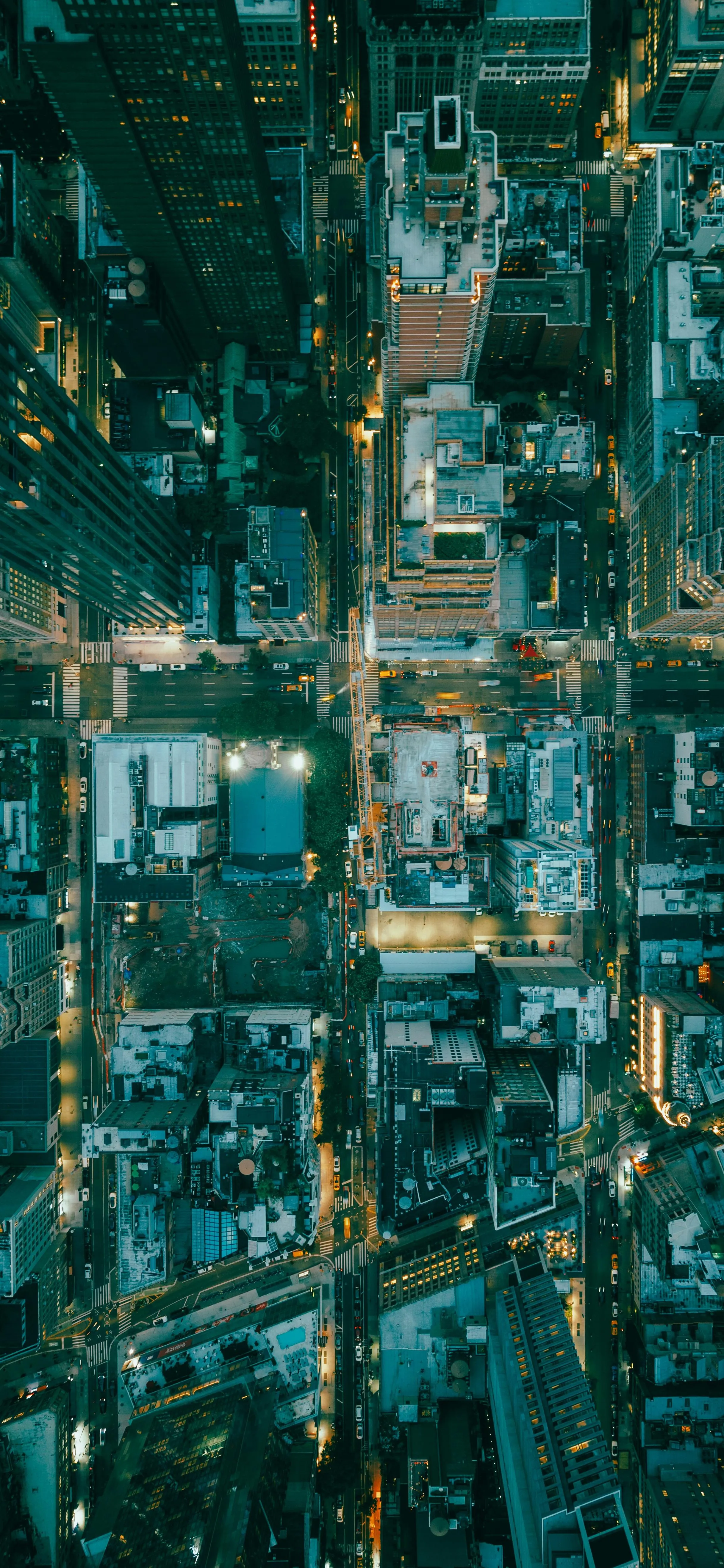 Top Down View of City Streets and Buildings at Night