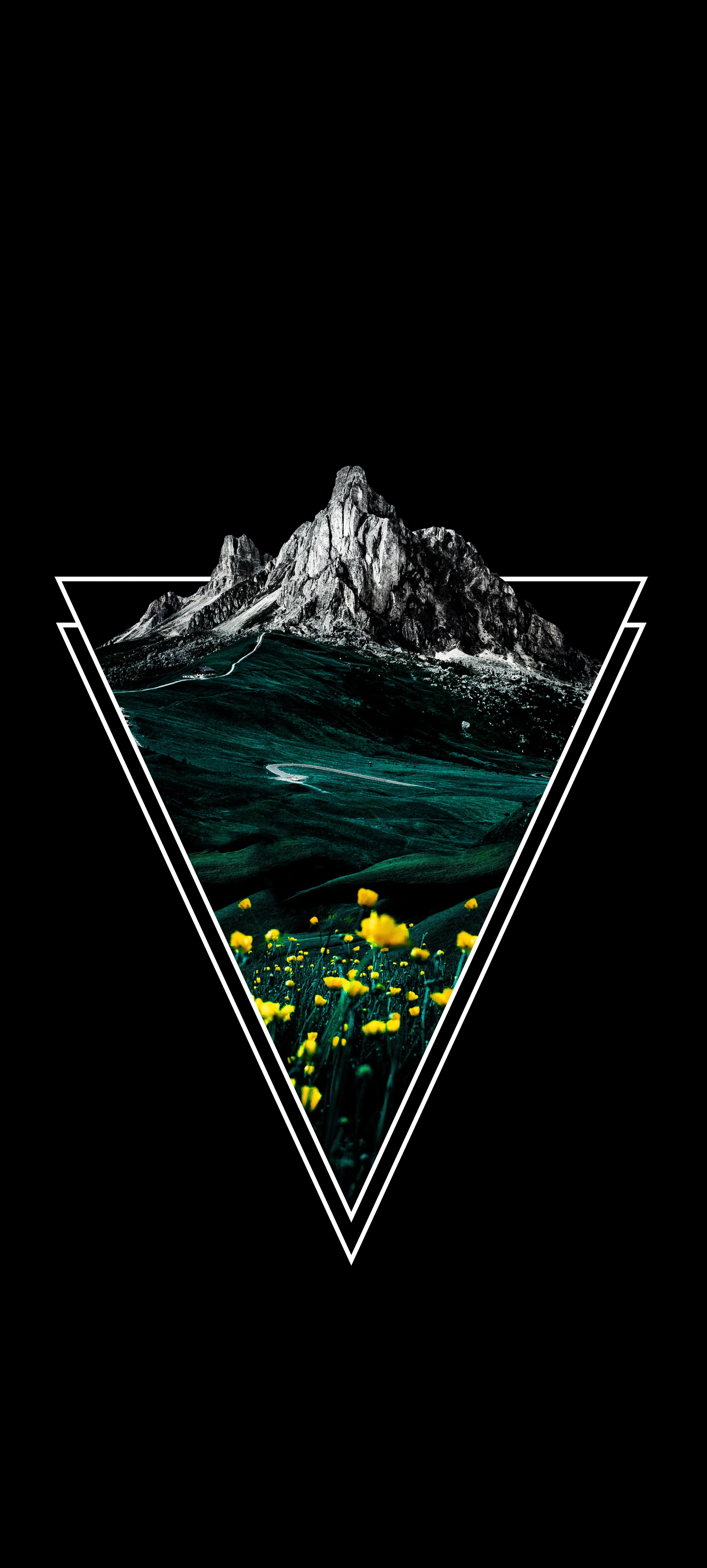 Triangular Glass Container Holding Small Mountains Inside