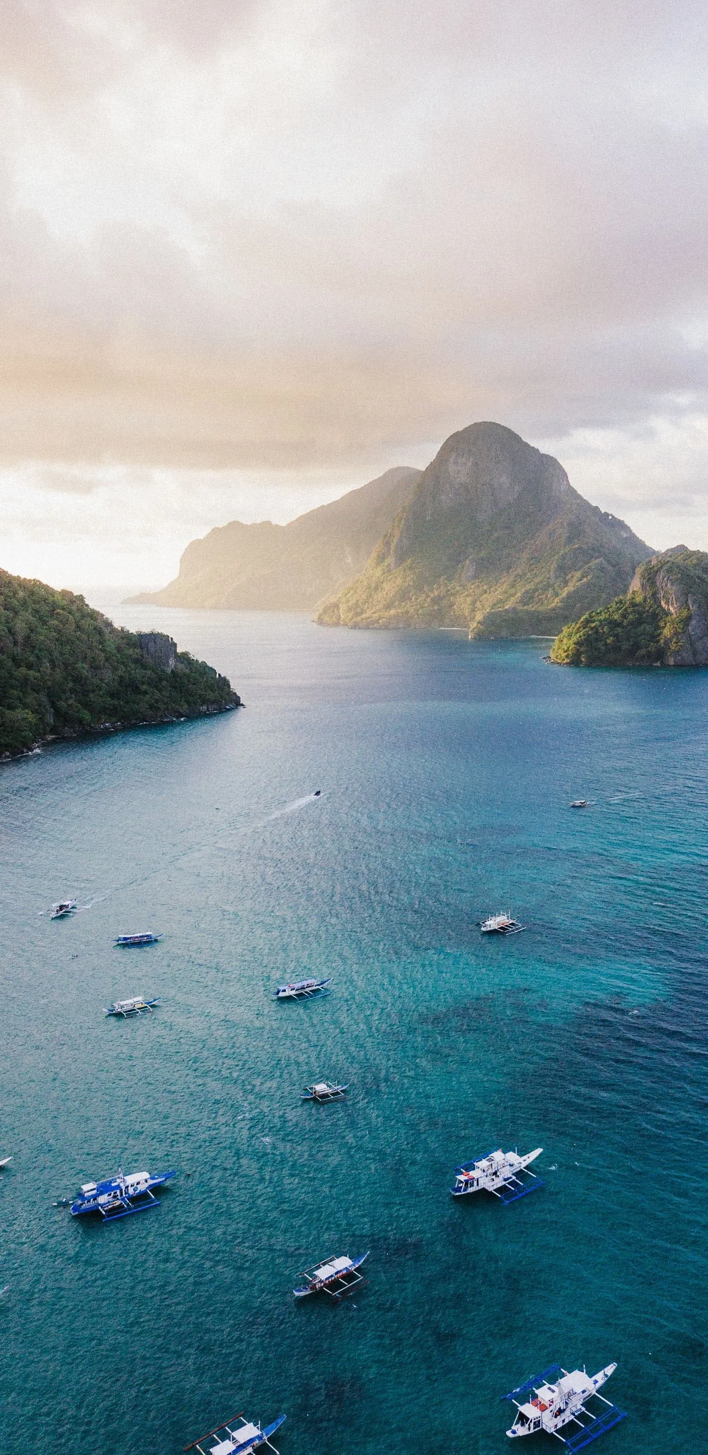 Tropical Island with Boats in Blue Ocean at Sunrise
