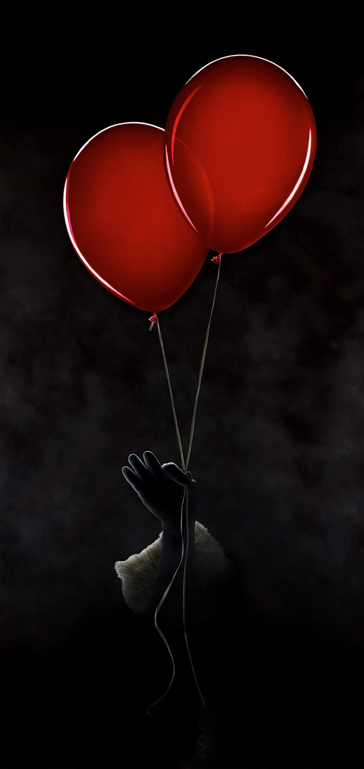 Two Red Heart Balloons Floating in Dark Scene Wallpaper