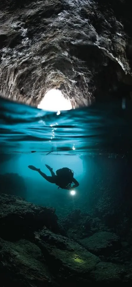 Underwater View with Light Rays and Cave Scene Wallpaper