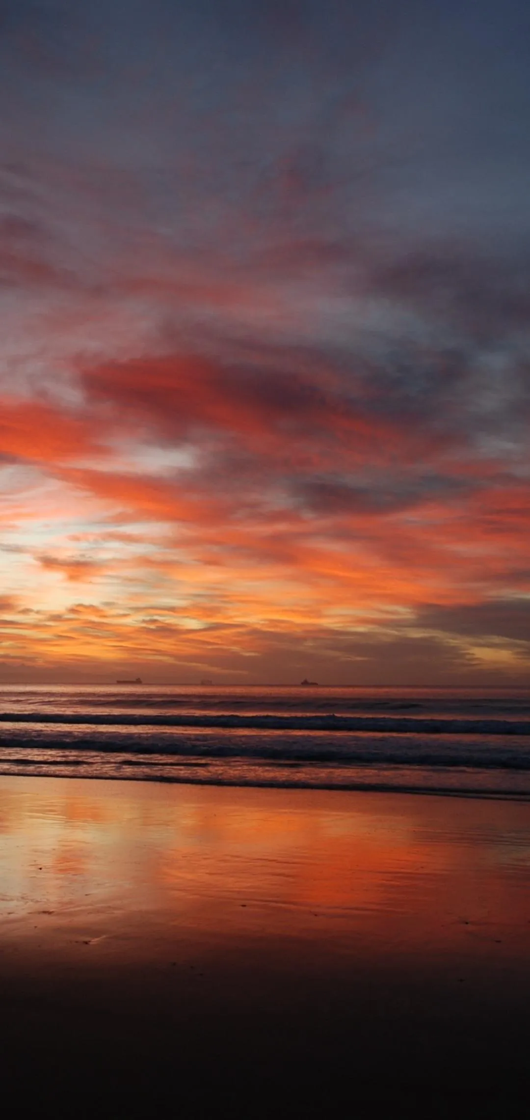 Vibrant Ocean Sunset with Fiery Red Orange Sky Wallpaper