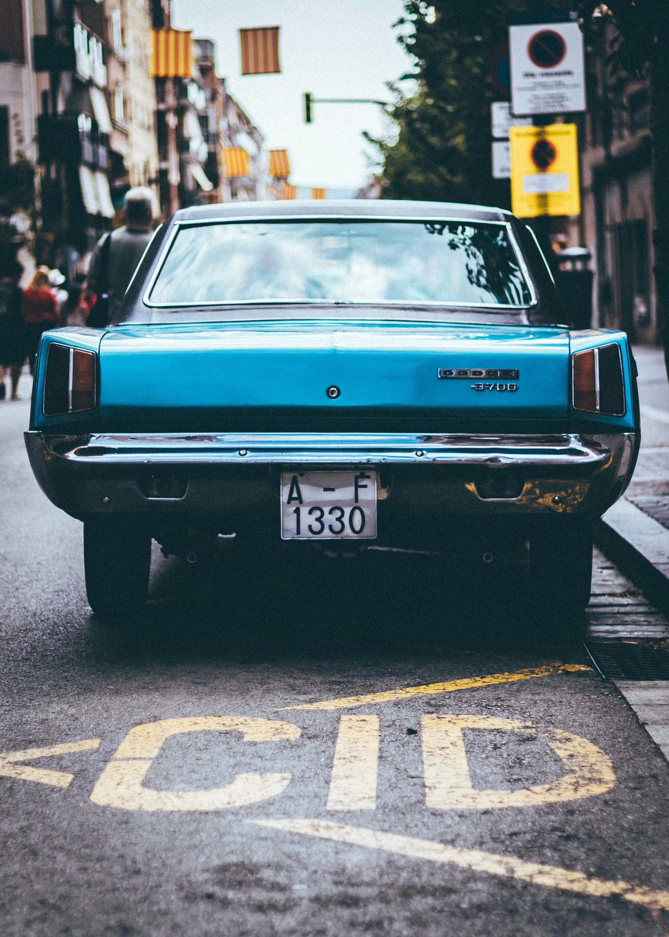 Vintage Blue Car Parked in Retro Urban Street Wallpaper