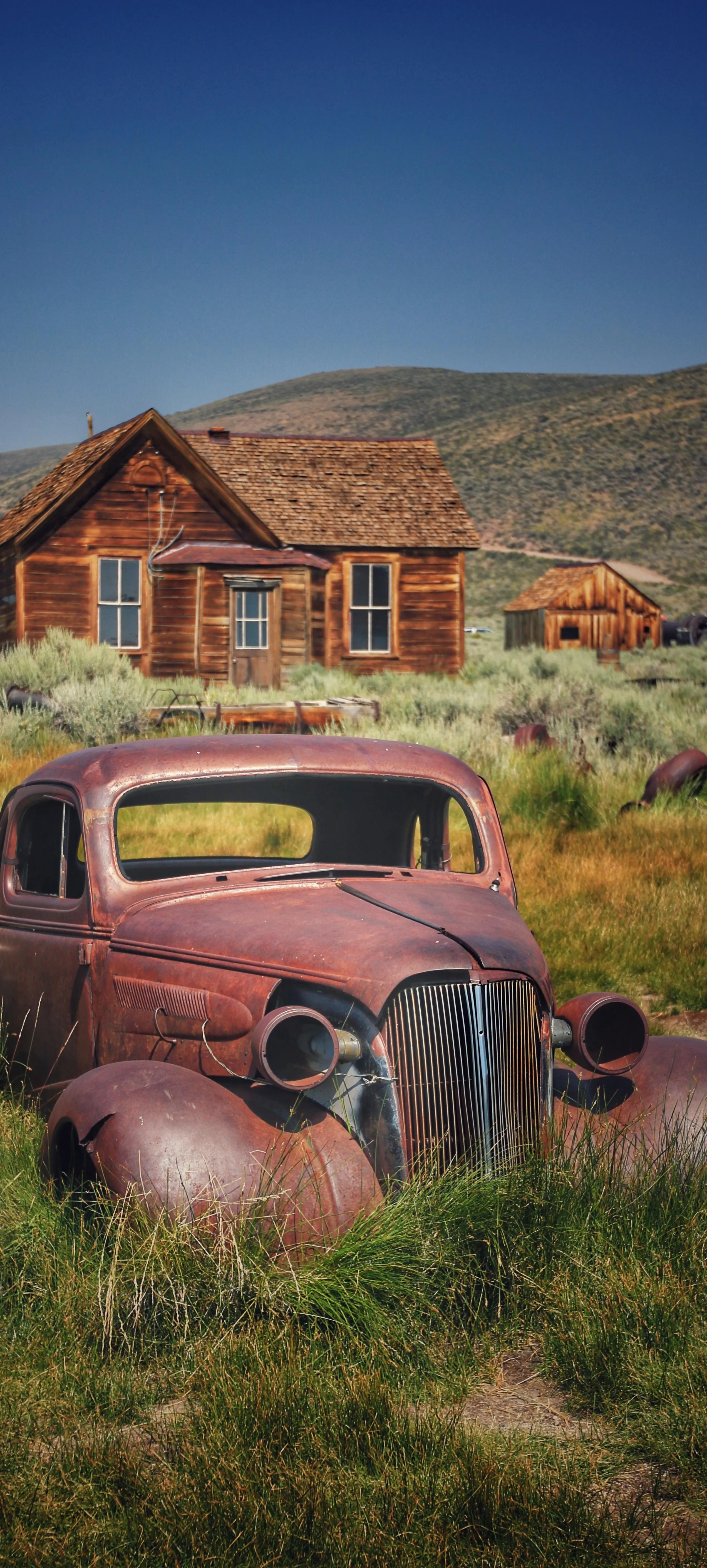 Vintage Car in Front of Wooden Cabin in Countryside