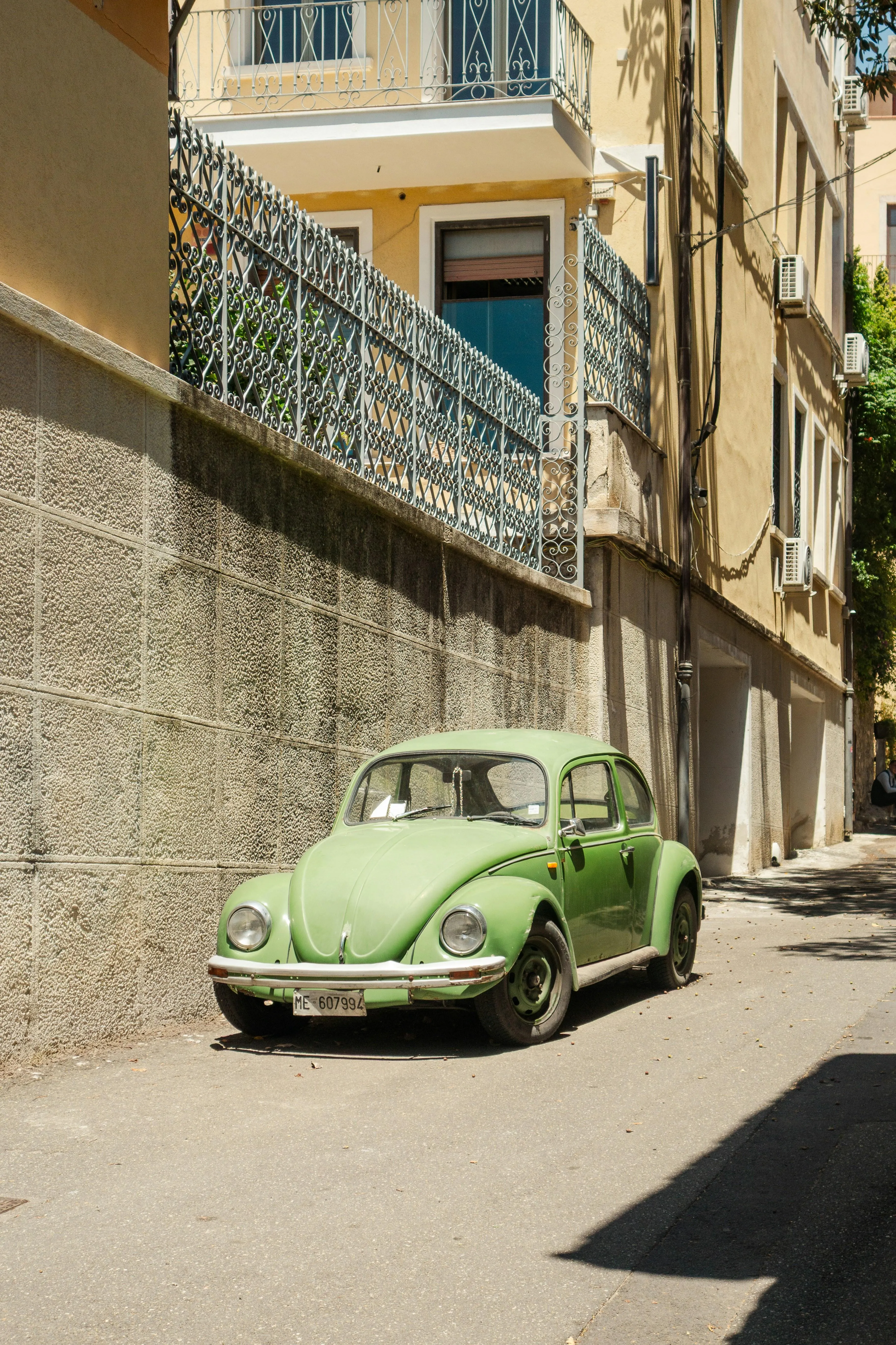 Vintage Green Beetle Car in Narrow European Alleyway