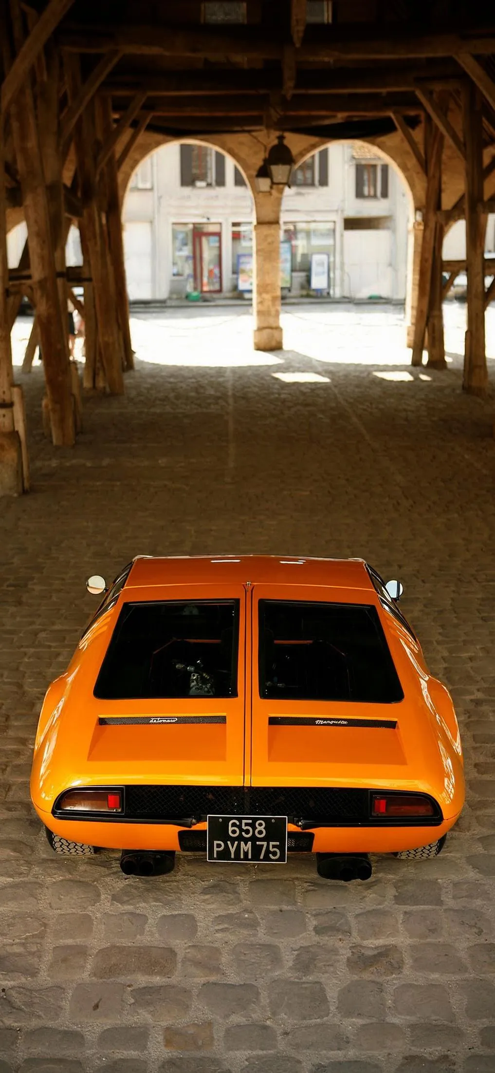 Vintage Orange Sports Car in Old Building Wallpaper