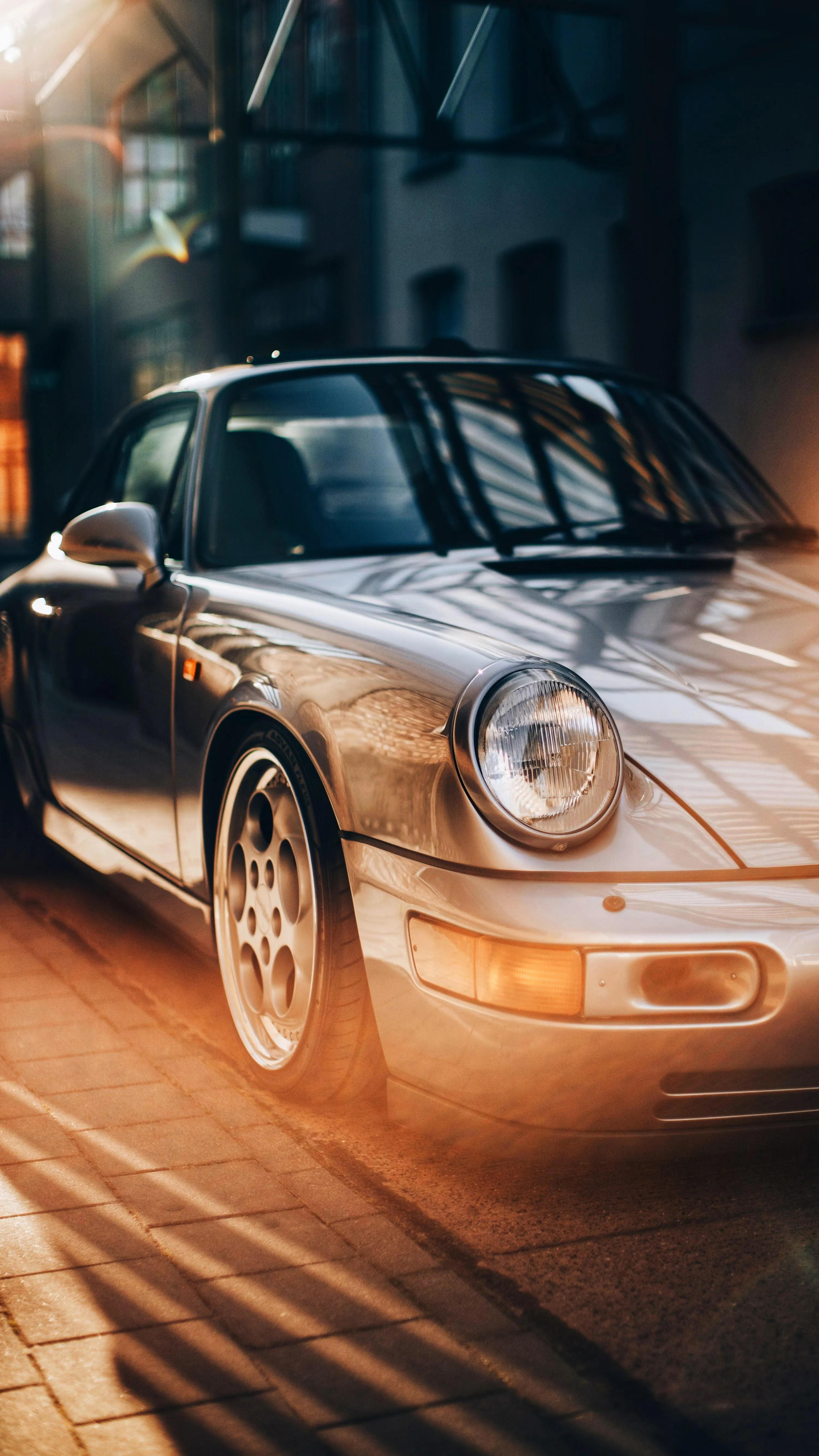 Vintage Silver Car Driving Fast Through City Lights