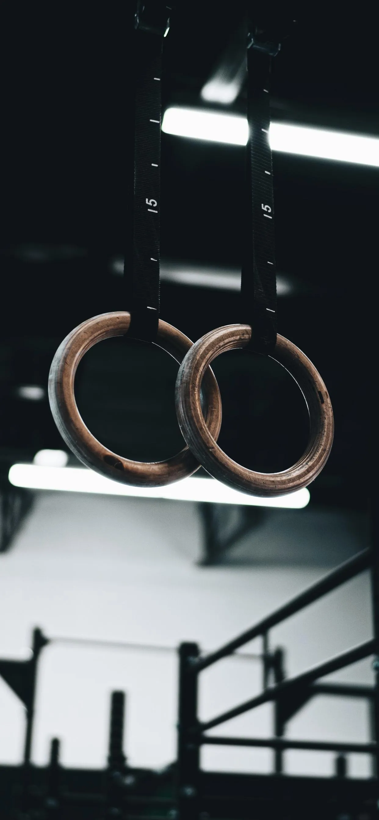 Wallpaper of Minimalist Gym Rings Symbolizing Strength Focus