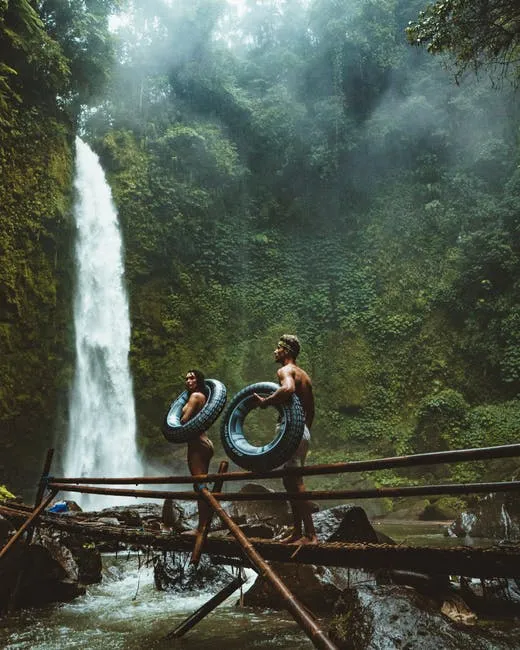 Waterfall Scene With People Standing on Wooden Bridge