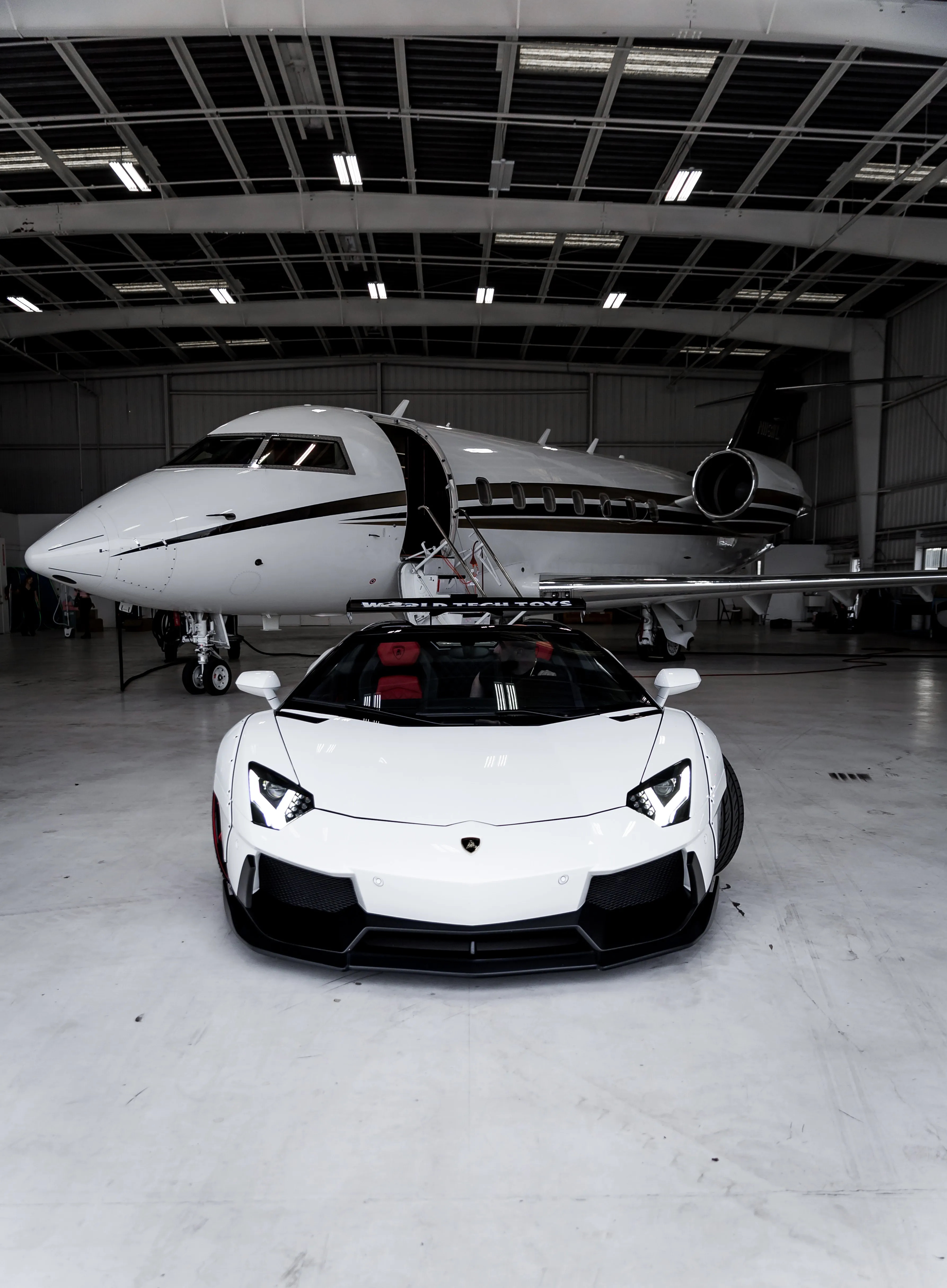White Car and Jet in Modern Airport Hangar Wallpaper