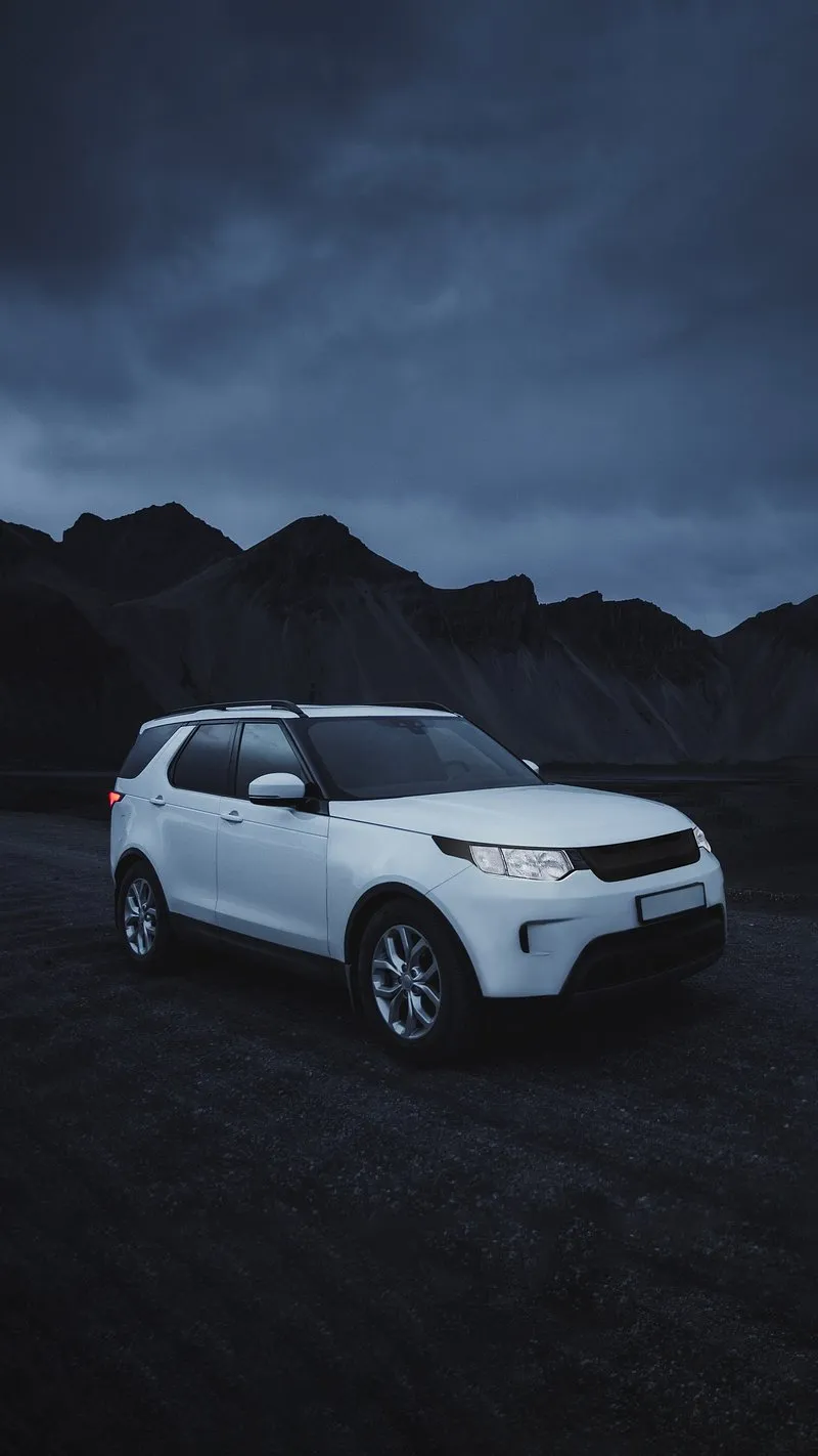 White Luxury Car on A Dark Road at Night Mobile Wallpaper