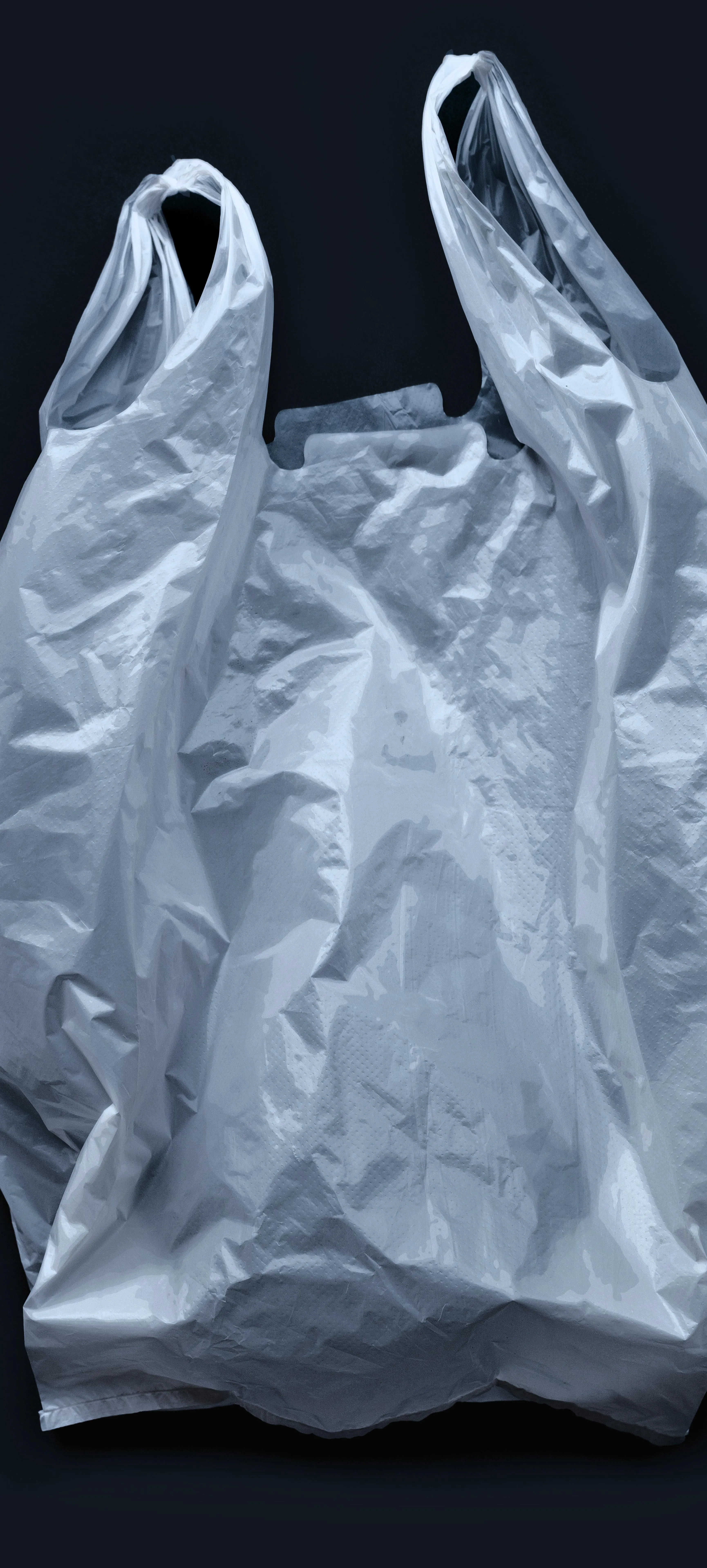 White Plastic Shopping Bag Against Dark Background